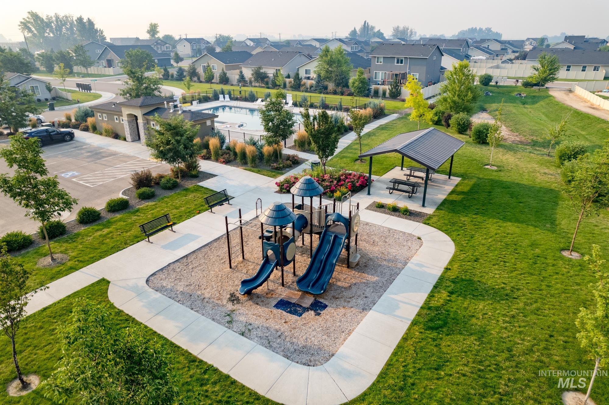 View of community with a patio area, a lawn, and a residential view