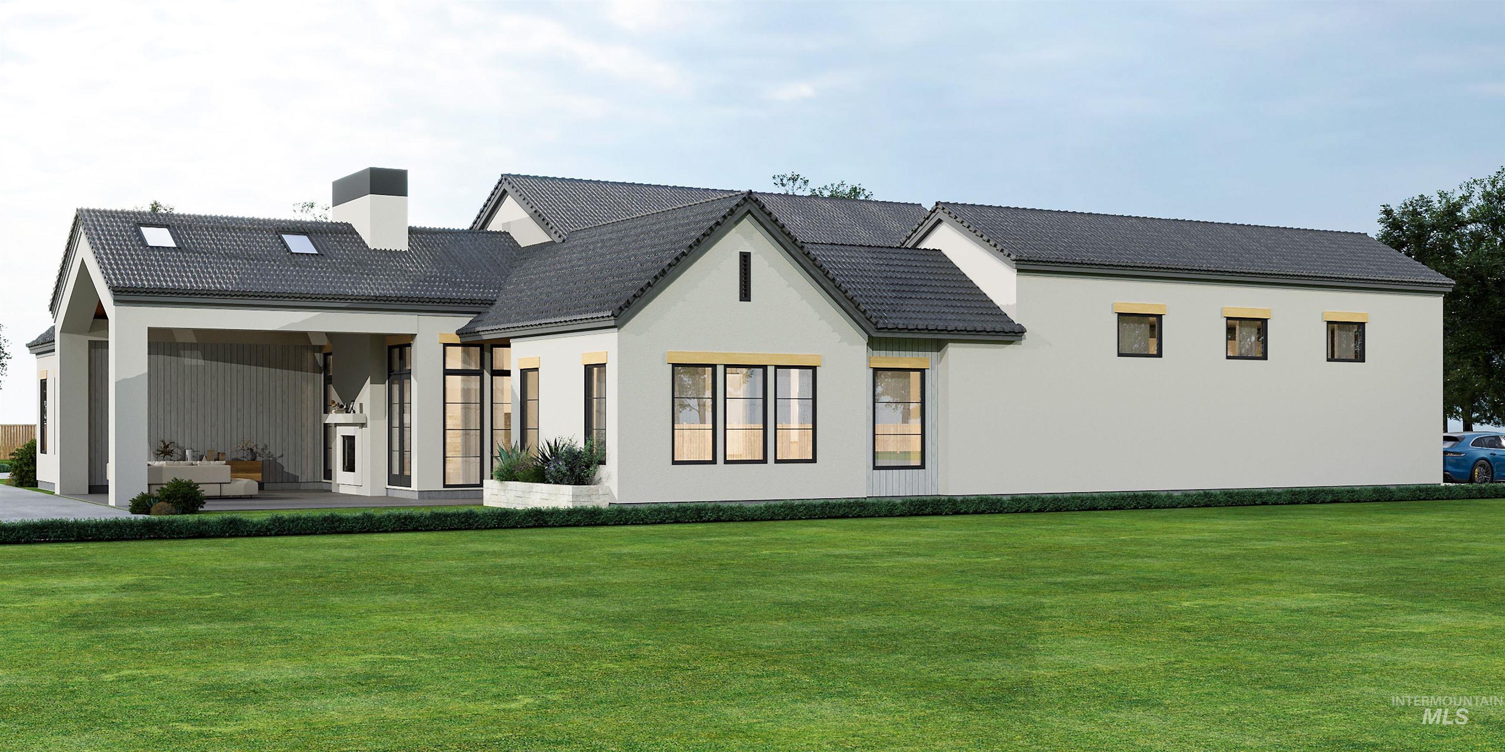 Rear view of property featuring a lawn, a chimney, stucco siding, and a tile roof