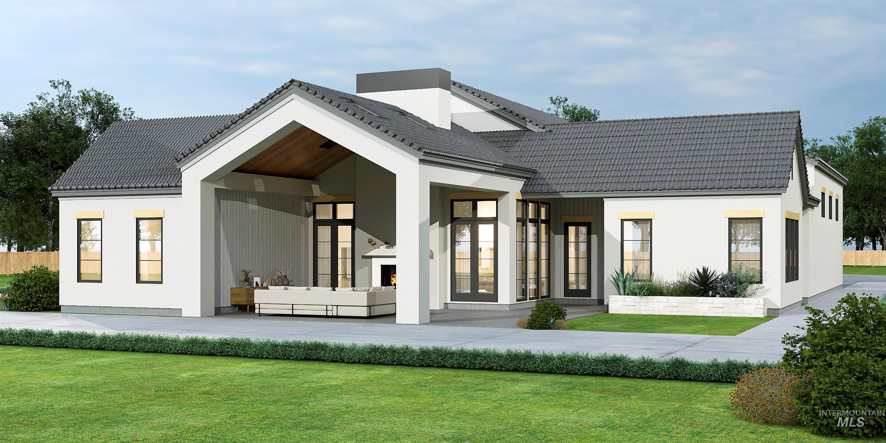 Back of house featuring a lawn, a tiled roof, and a patio area