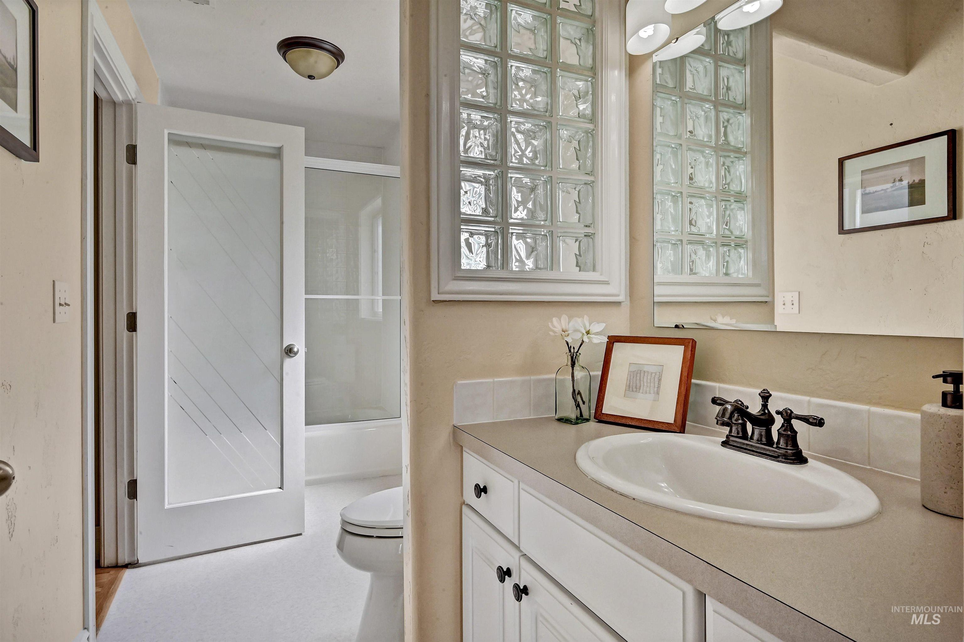 Bathroom featuring vanity and shower / bath combination