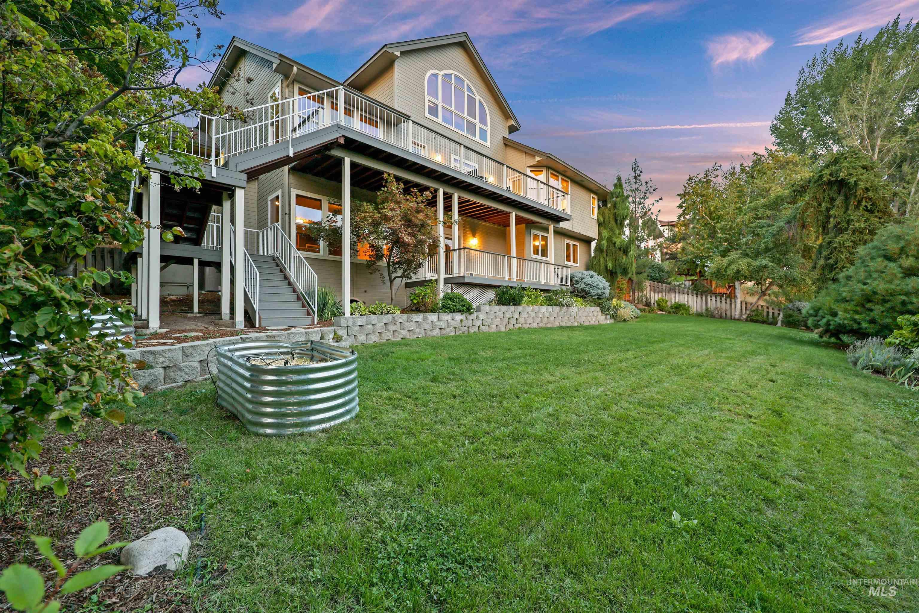 Back of property at dusk featuring stairway
