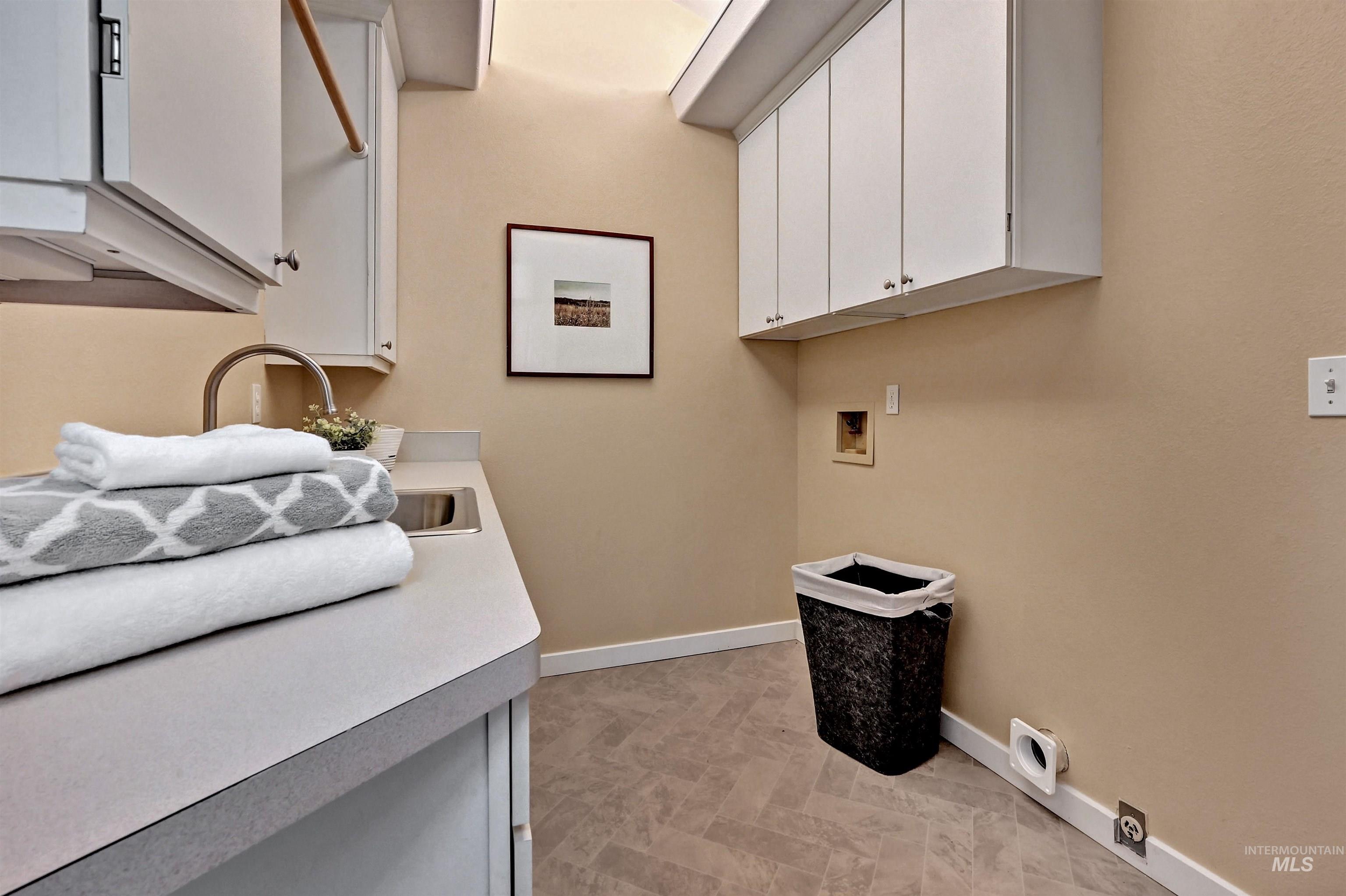 Laundry room featuring hookup for a washing machine and cabinet space