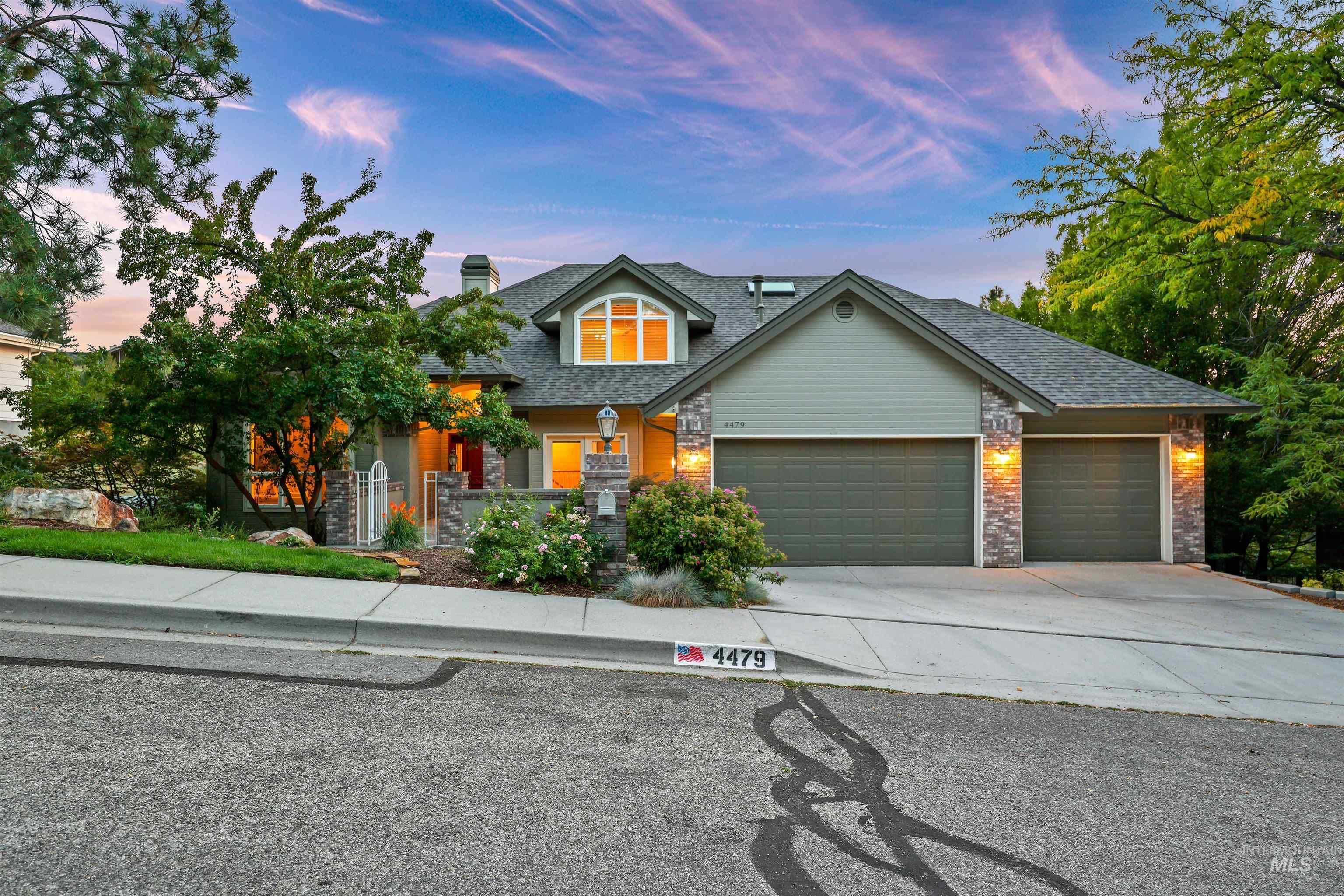 Craftsman house with concrete driveway, a garage, a chimney, brick siding, and a shingled roof