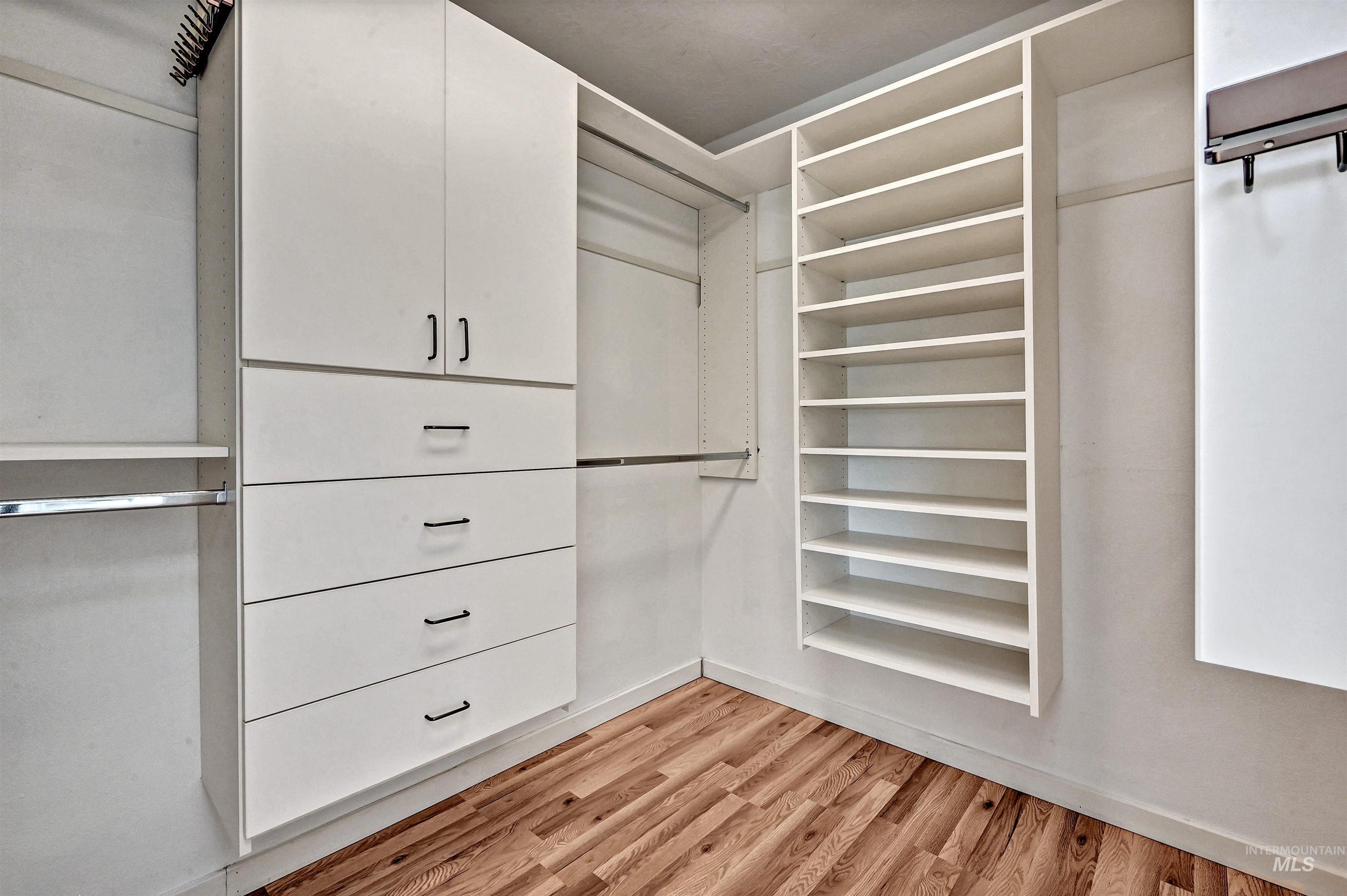 Walk in closet featuring light wood-style flooring