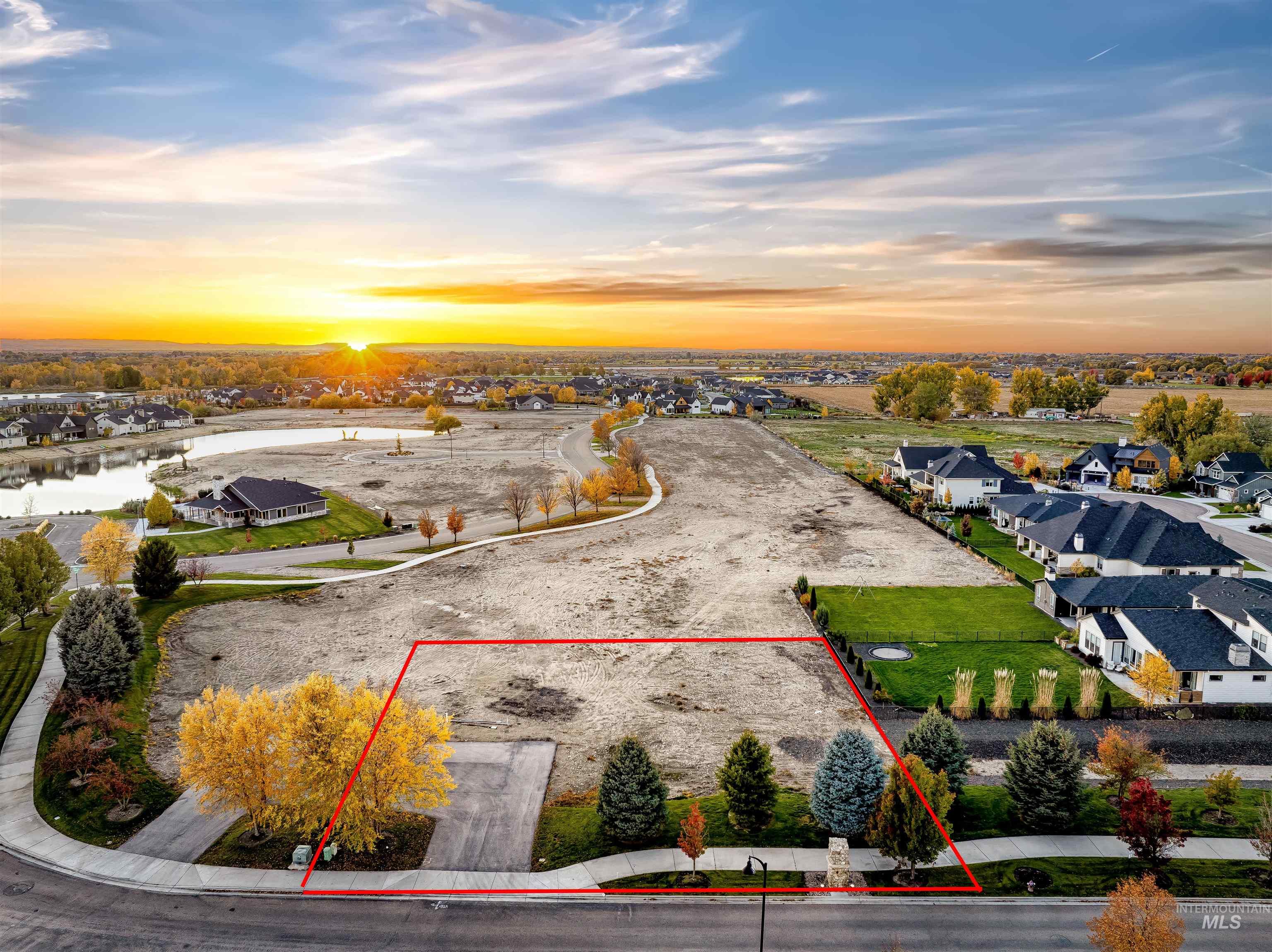 Aerial view at dusk of a residential view and property parcel outlined