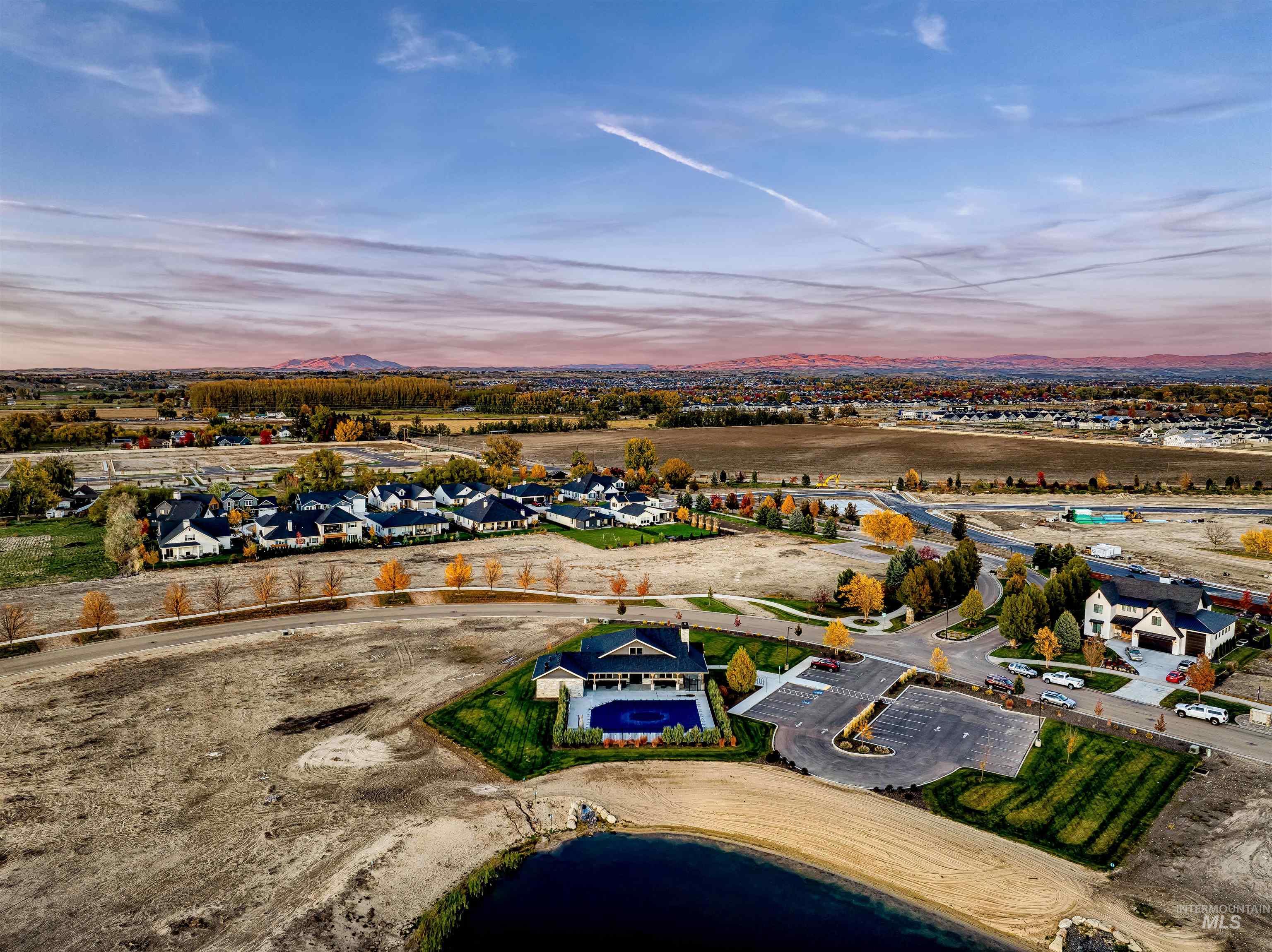 Aerial perspective of suburban area featuring a large body of water