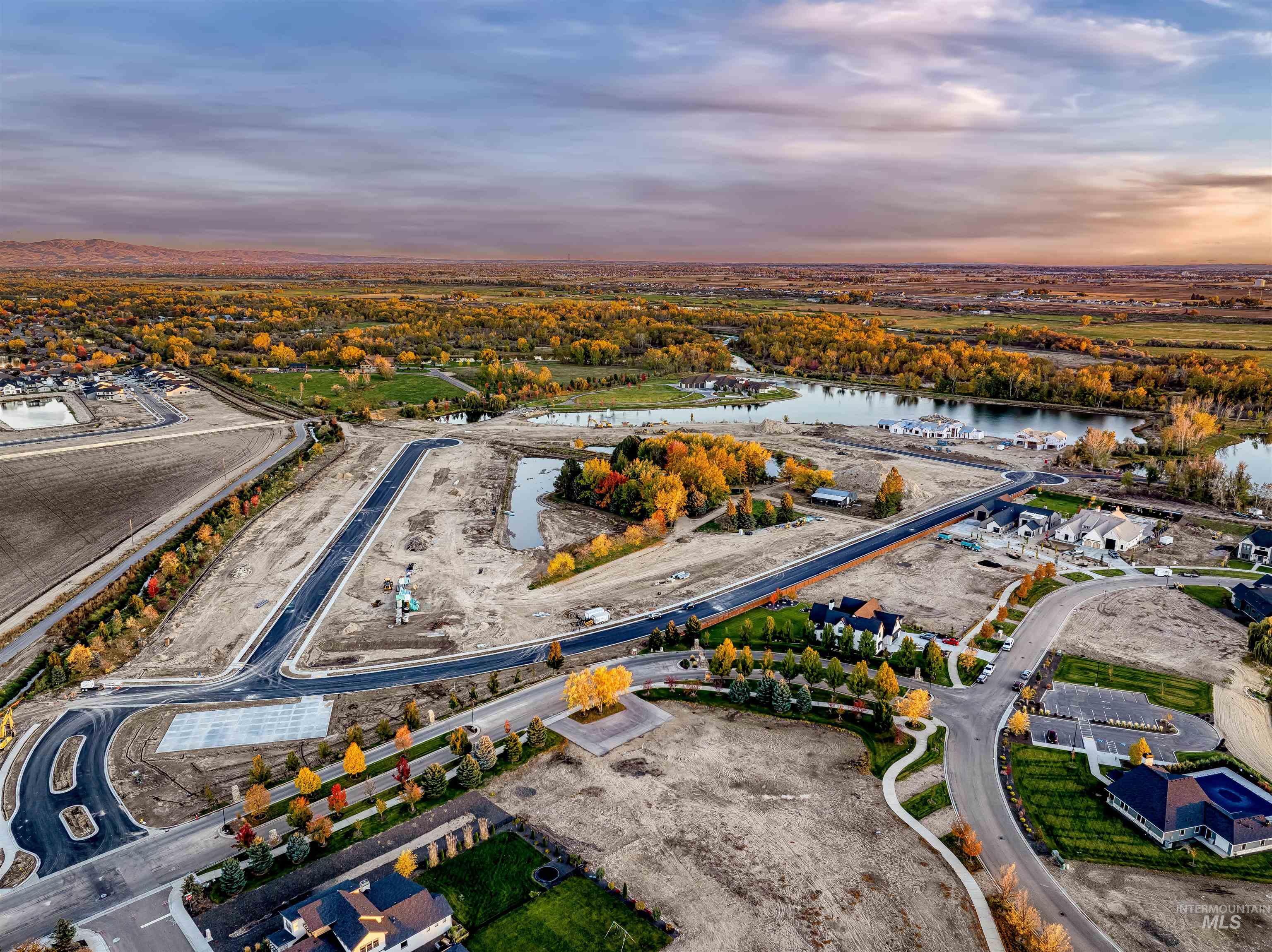 Aerial view of property and surrounding area featuring a nearby body of water