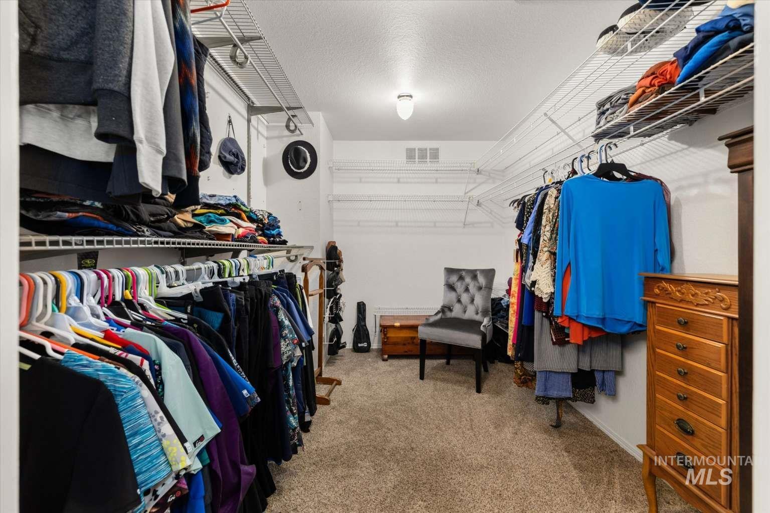 Walk in closet featuring light carpet