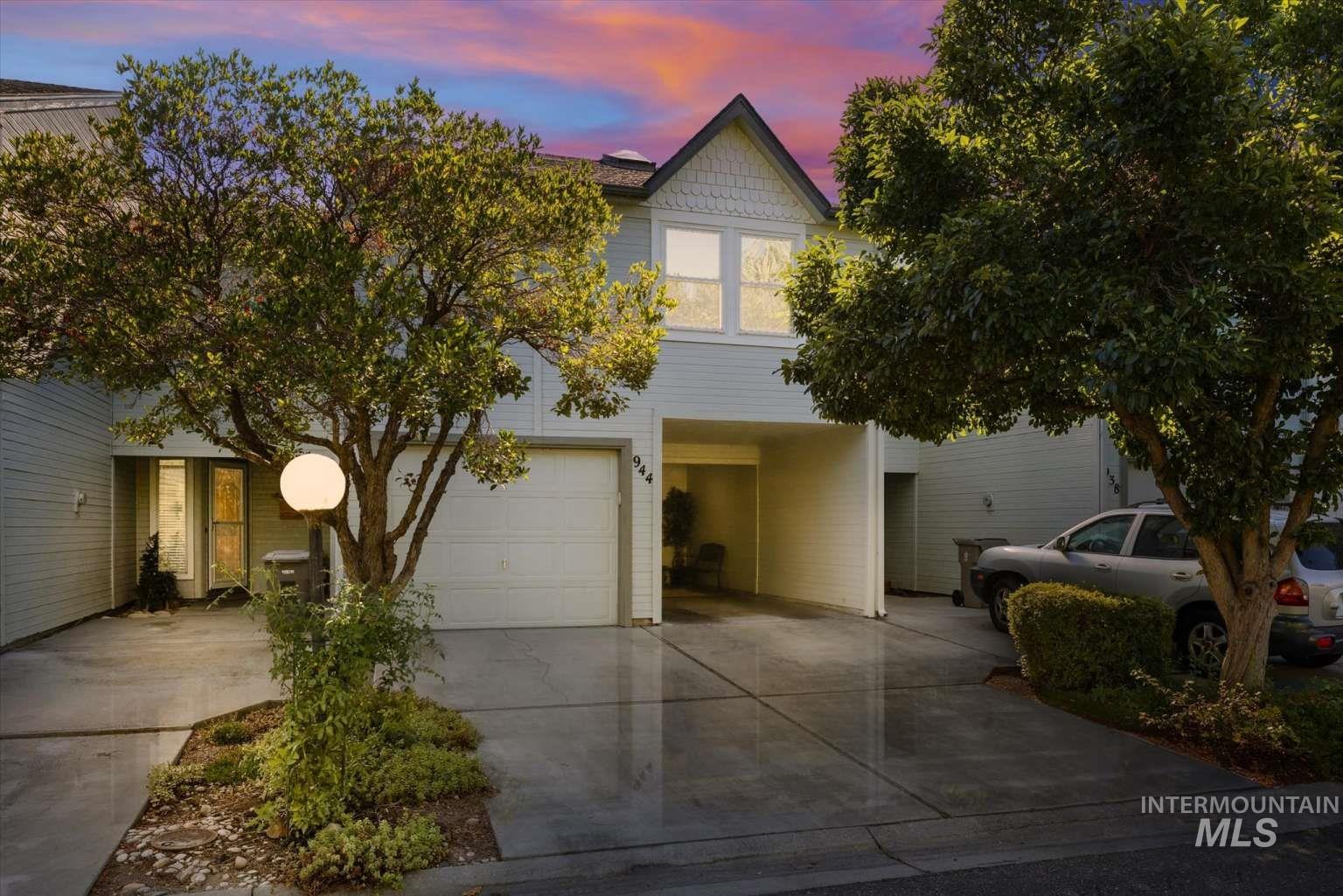 View of front of property featuring concrete driveway and an attached garage