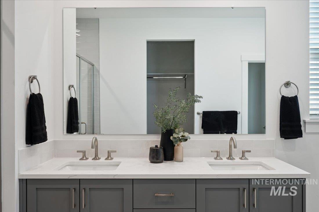 Bathroom with double vanity and a shower stall