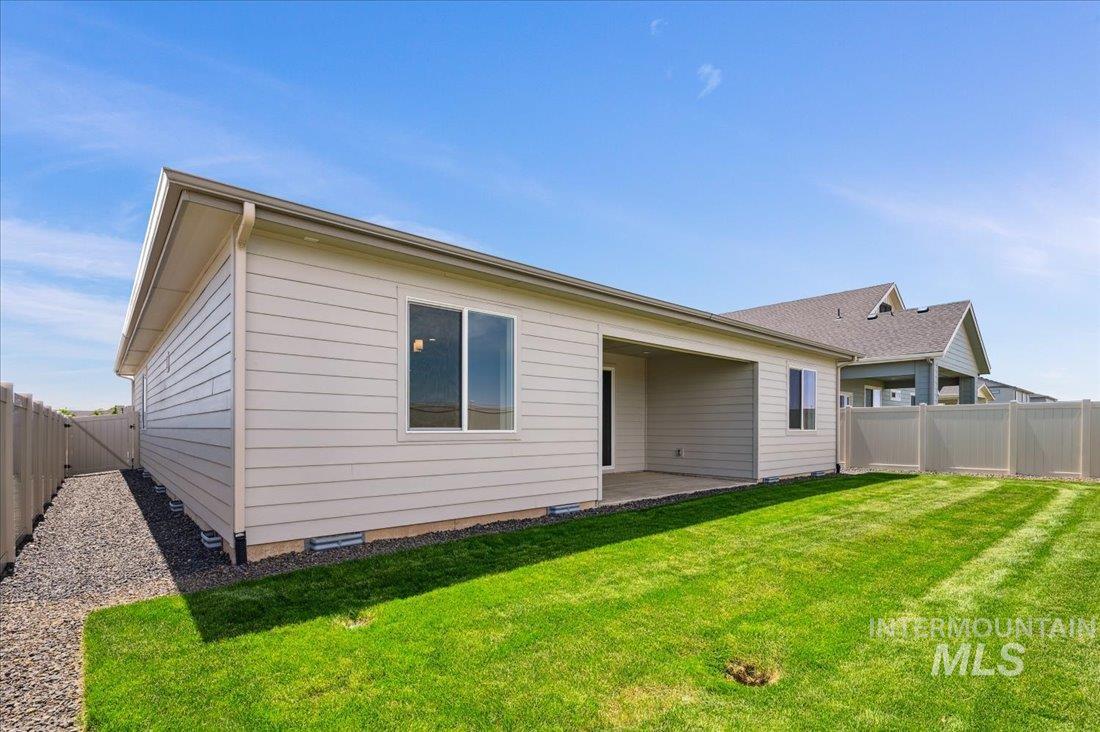 Rear view of house with a patio area and a fenced backyard