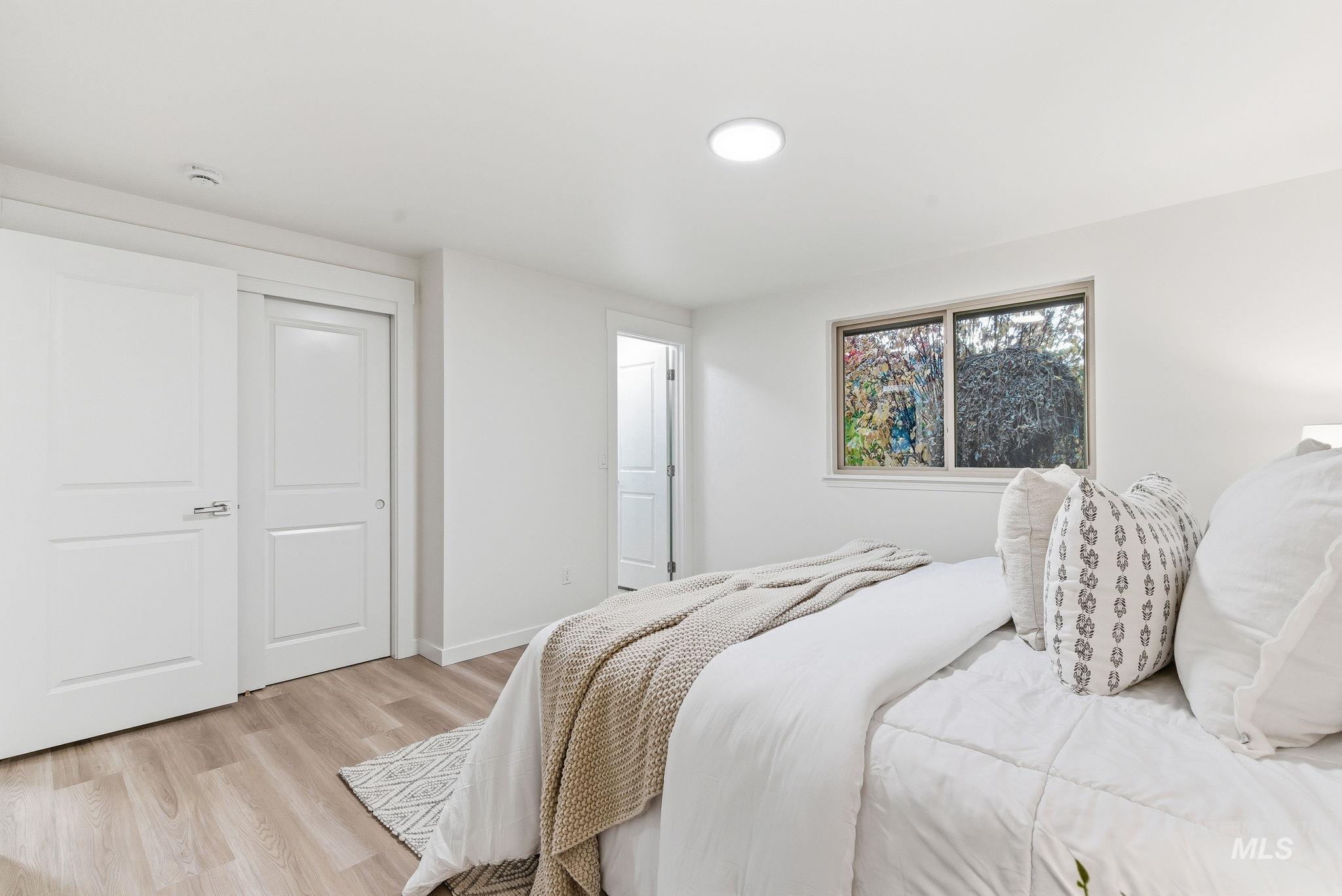 Bedroom featuring wood finished floors and a closet