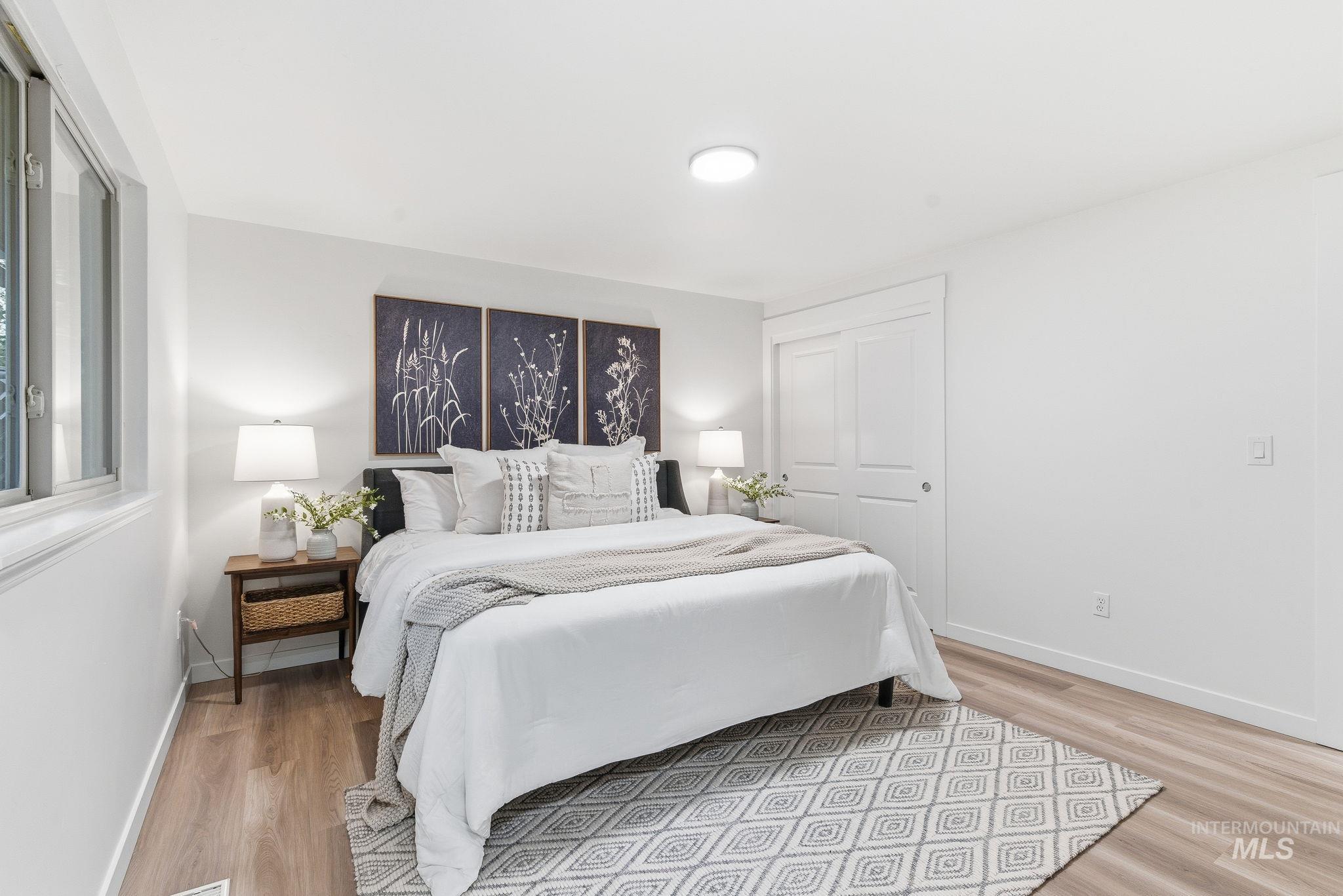 Bedroom with a closet and light wood-style floors