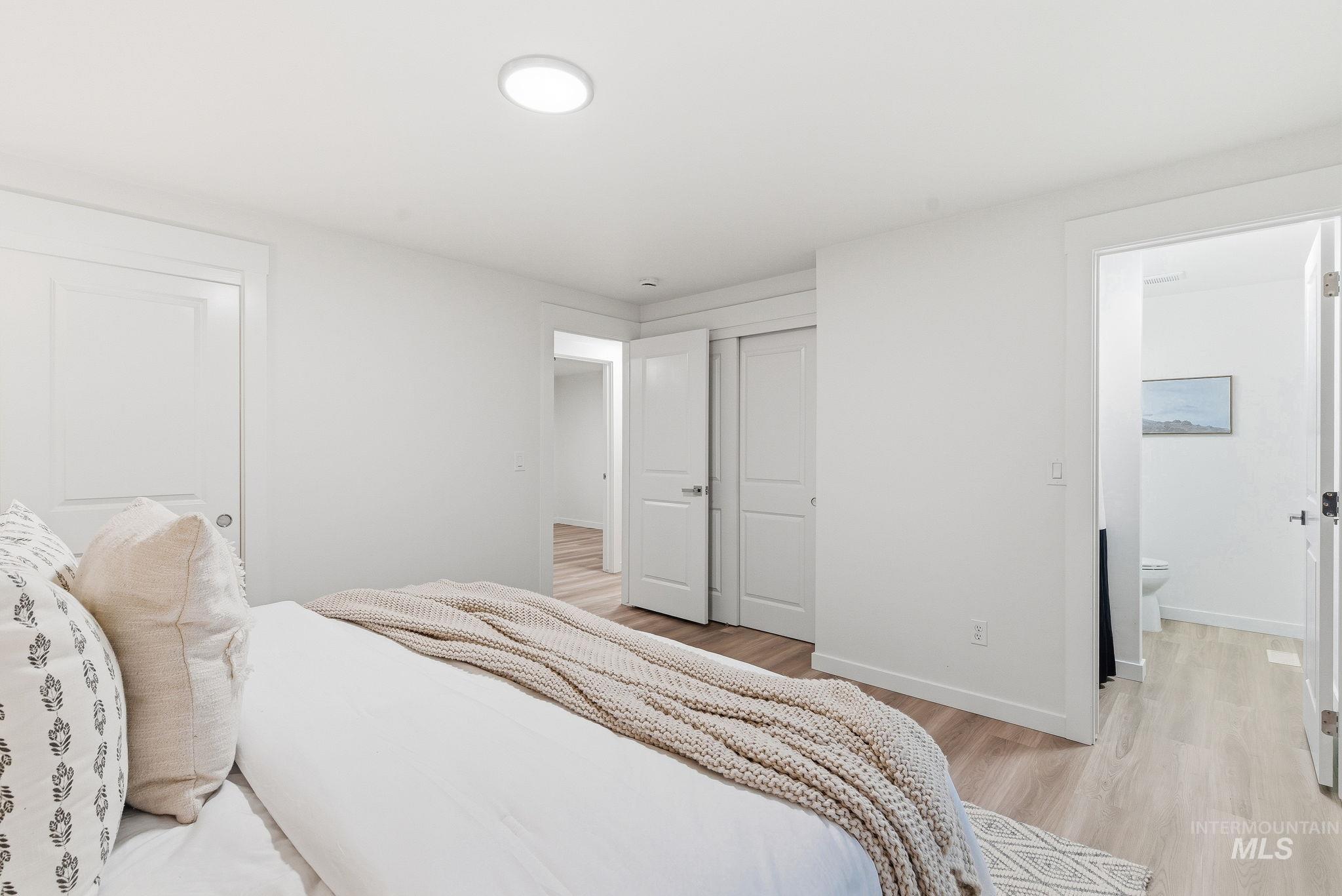 Bedroom featuring light wood-style floors and a closet