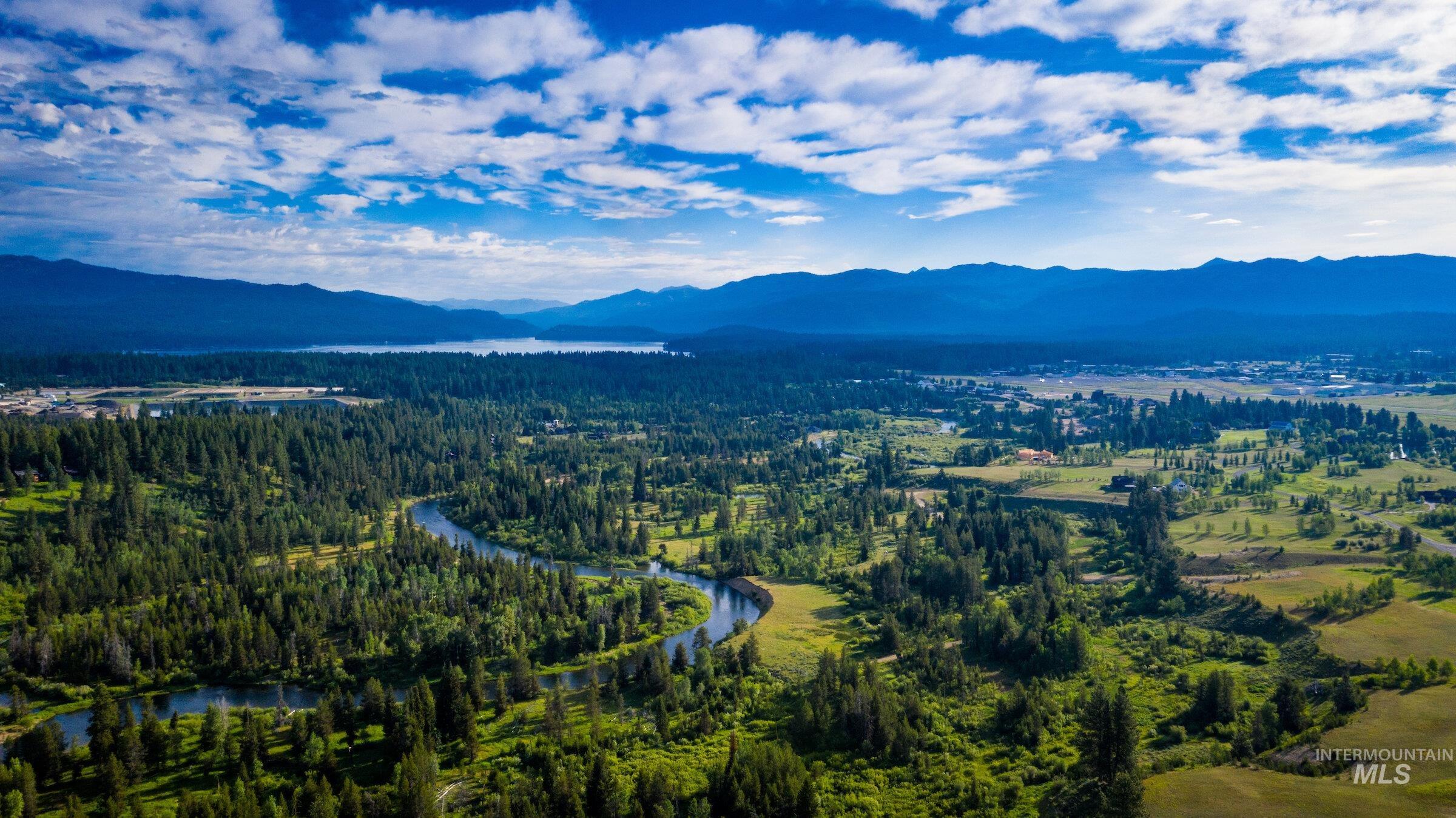 Bird's eye view of a heavily wooded area and a water and mountain view