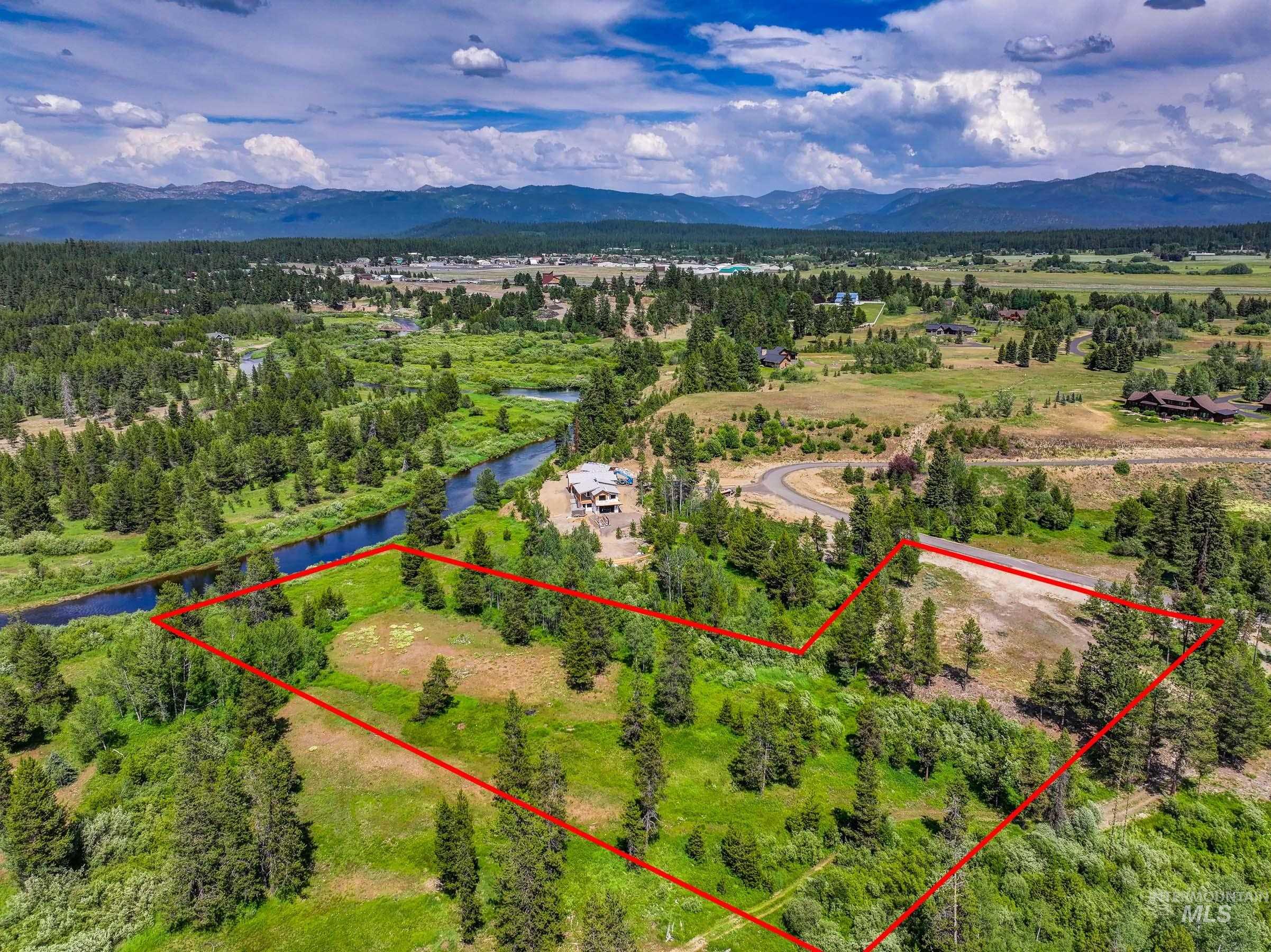 Aerial view of property's location featuring property parcel outlined and a water and mountain view