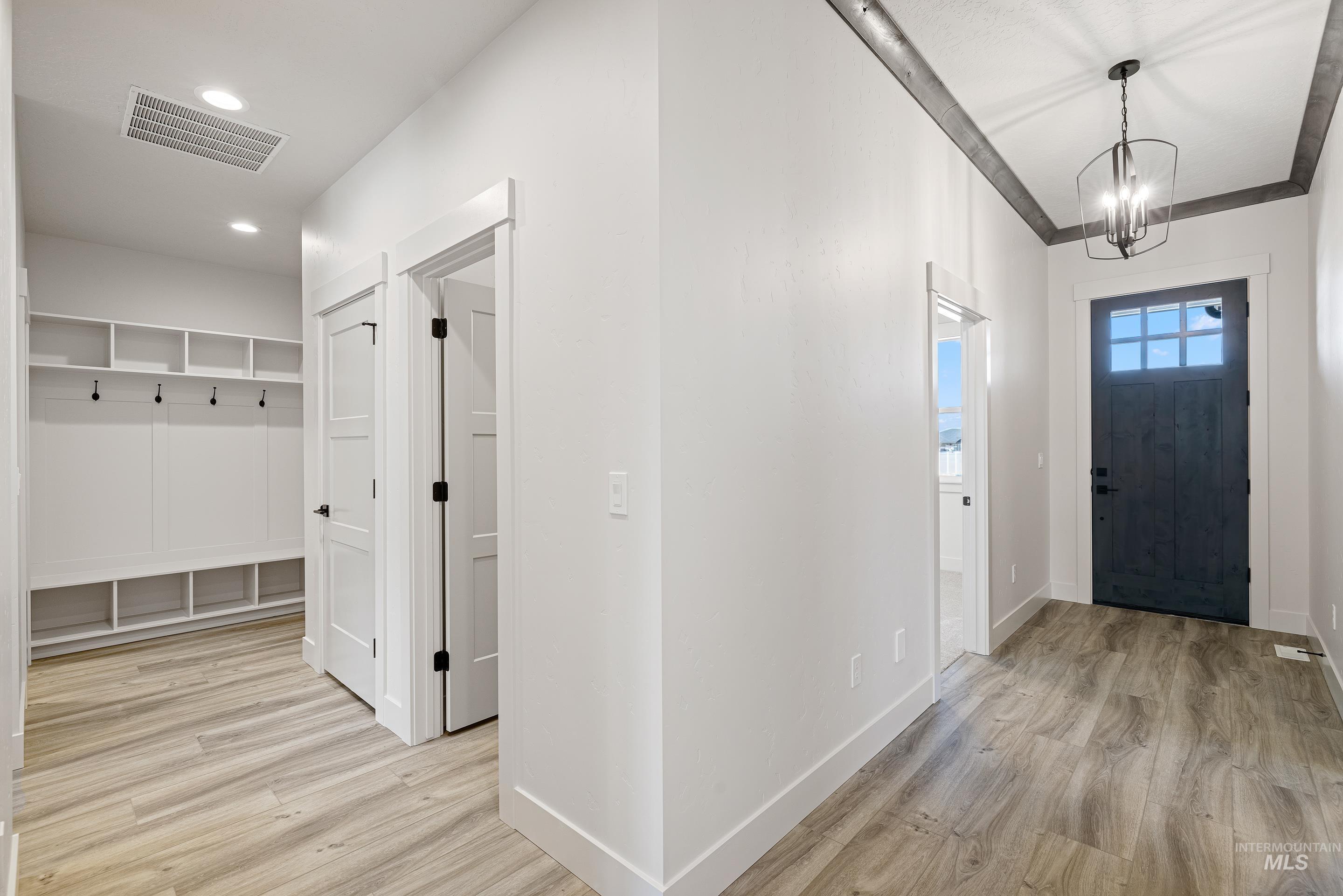 Entrance foyer featuring light wood-style floors and a chandelier