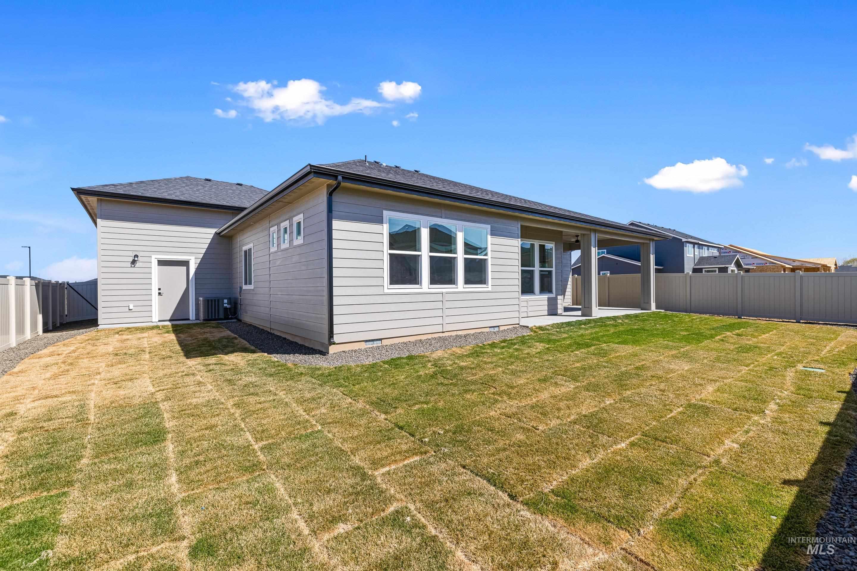 Back of house with a fenced backyard, a patio, and crawl space