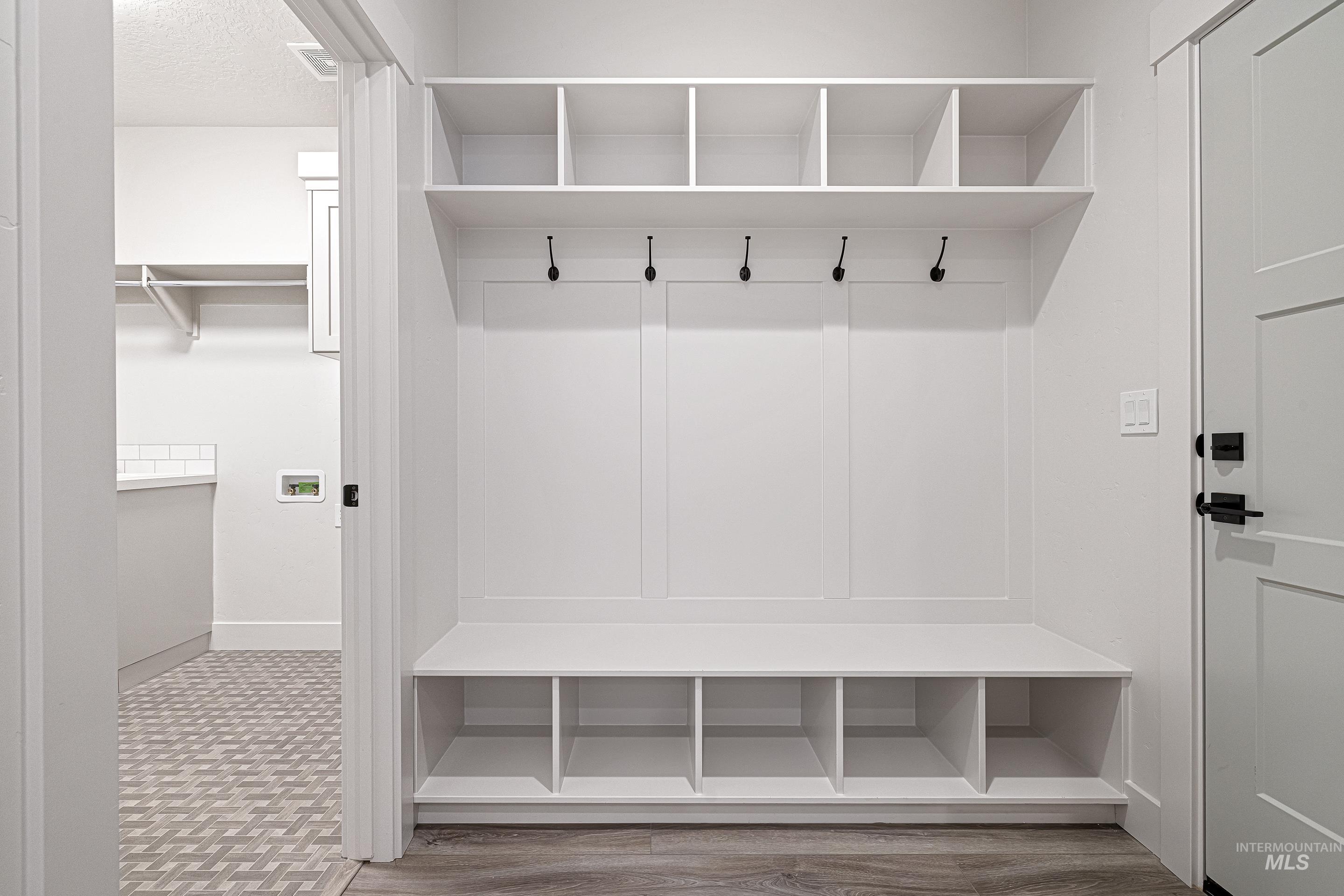 Mudroom with wood finished floors and a textured ceiling