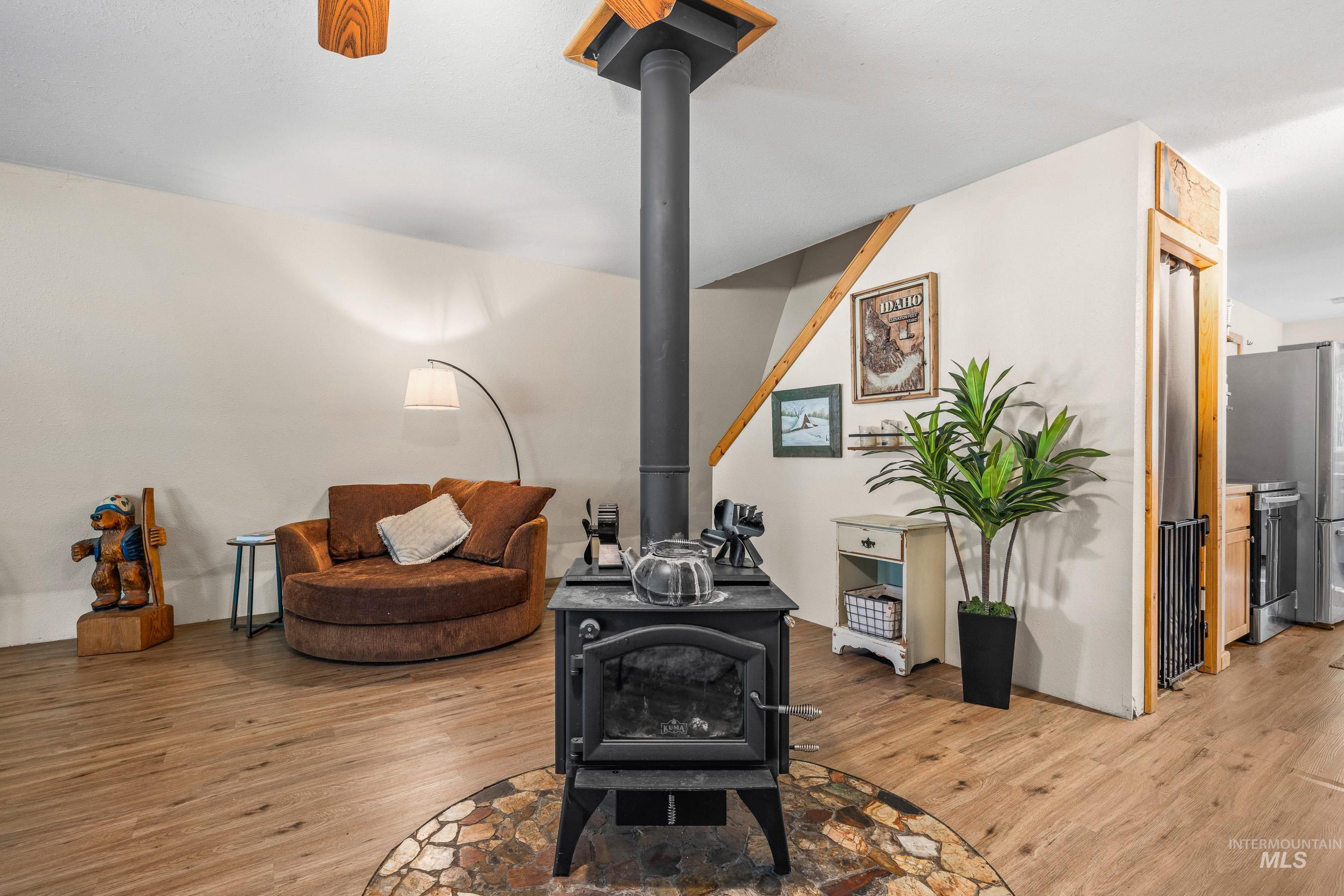 Living room with a wood stove and LVP flooring.