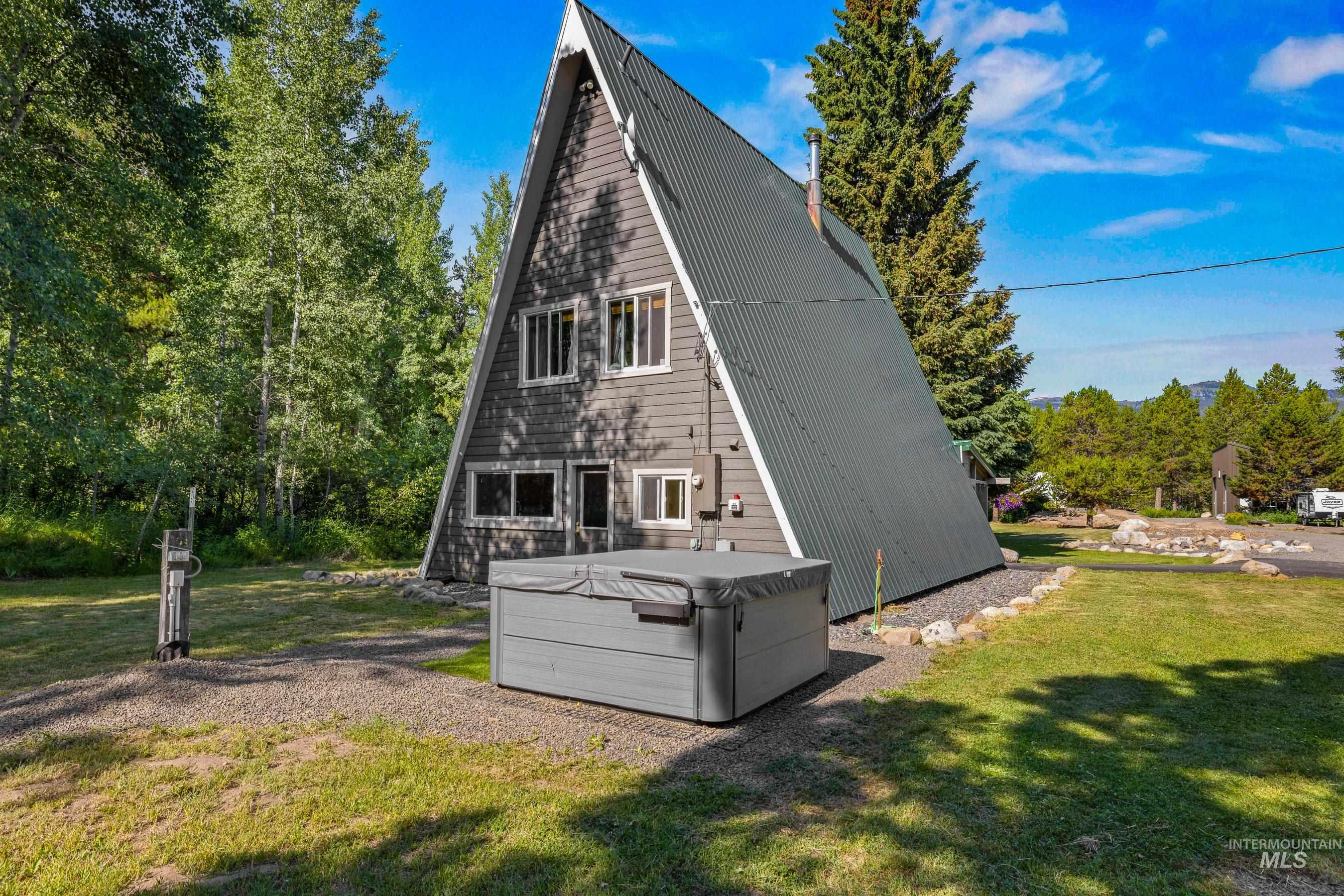 Rear view of house with hot tub