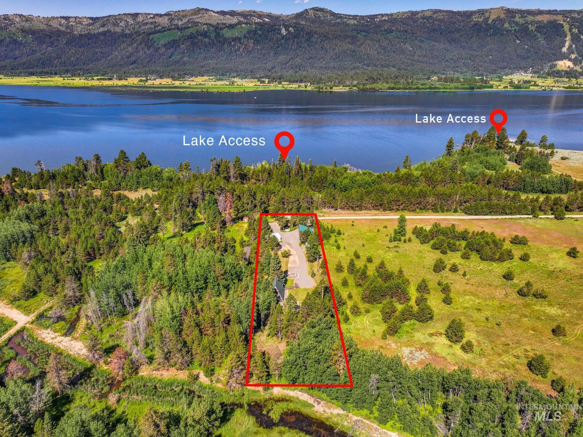Aerial view of property and surrounding area with a water and mountain view and property boundaries highlighted