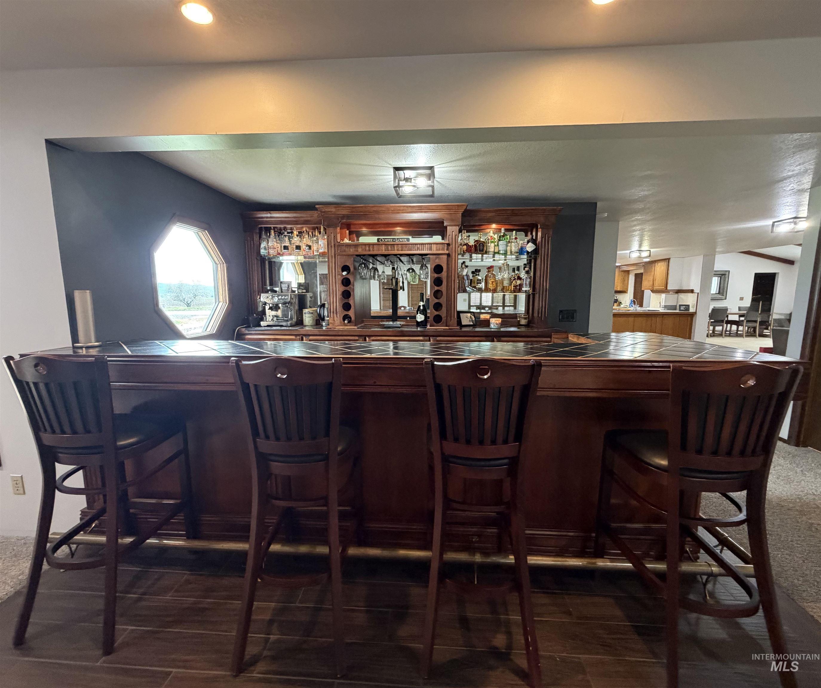 Custom-built wood bar with integrated shelving, glass racks, and wine storage