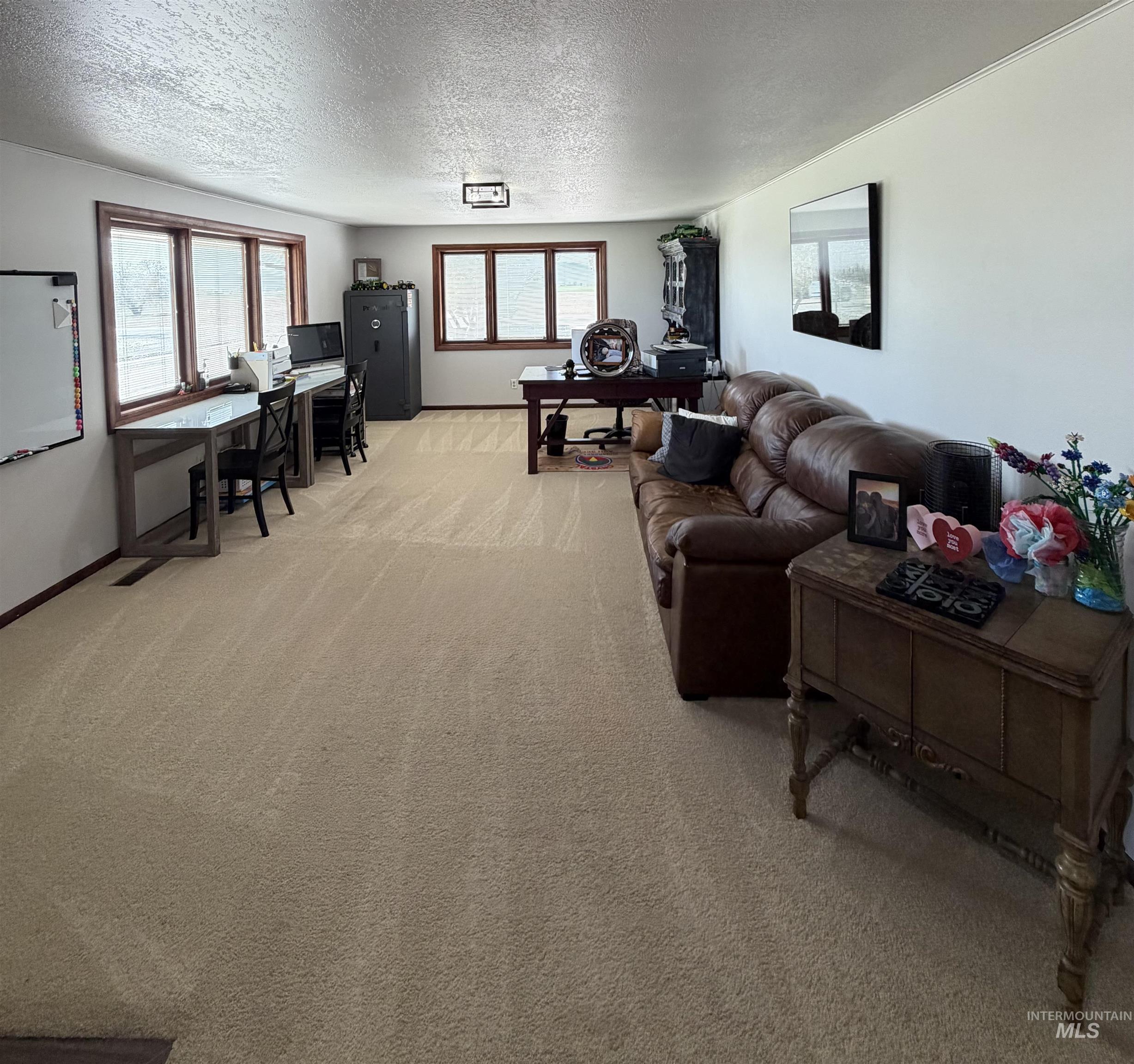 Spacious interior featuring neutral carpeting and white wall finishes