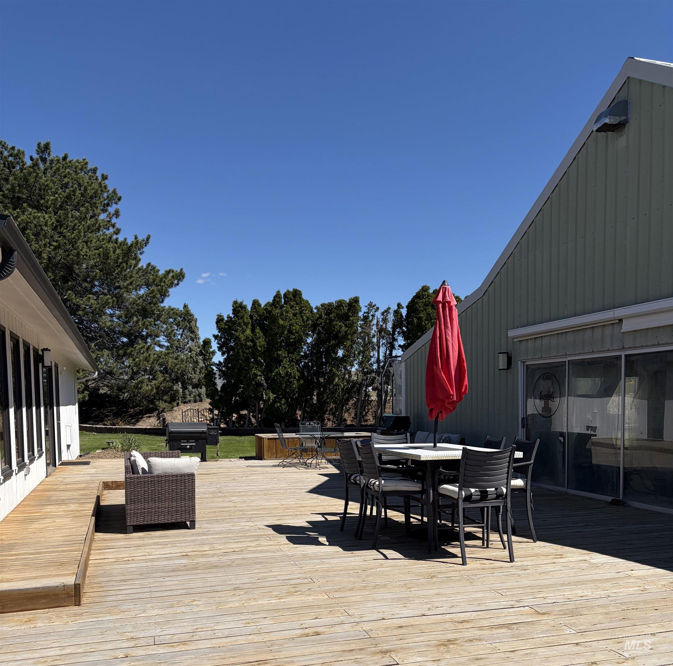 Expansive outdoor wood decking featuring a ramp access, direct exterior building access, and a sloped shed roofline