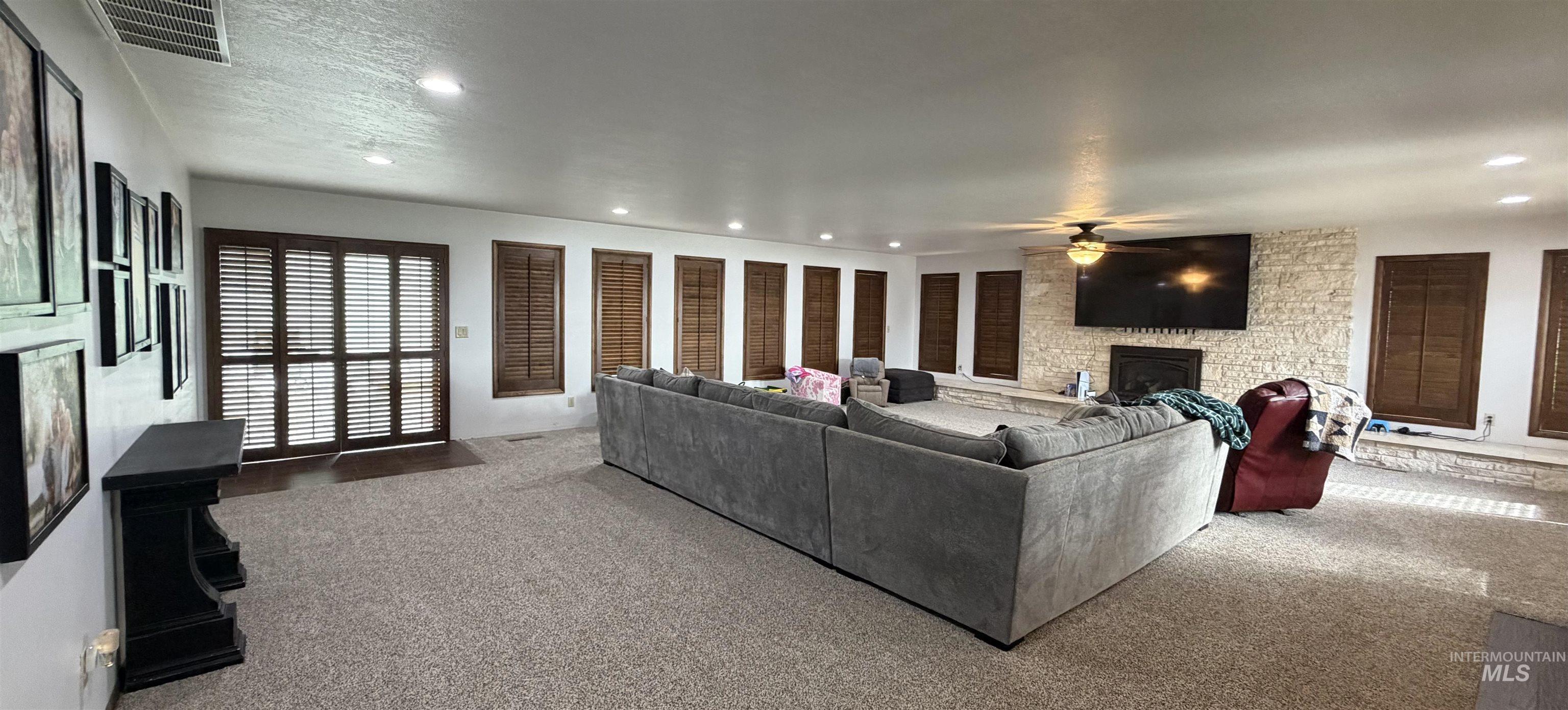 Spacious room featuring plush carpeting and recessed lighting