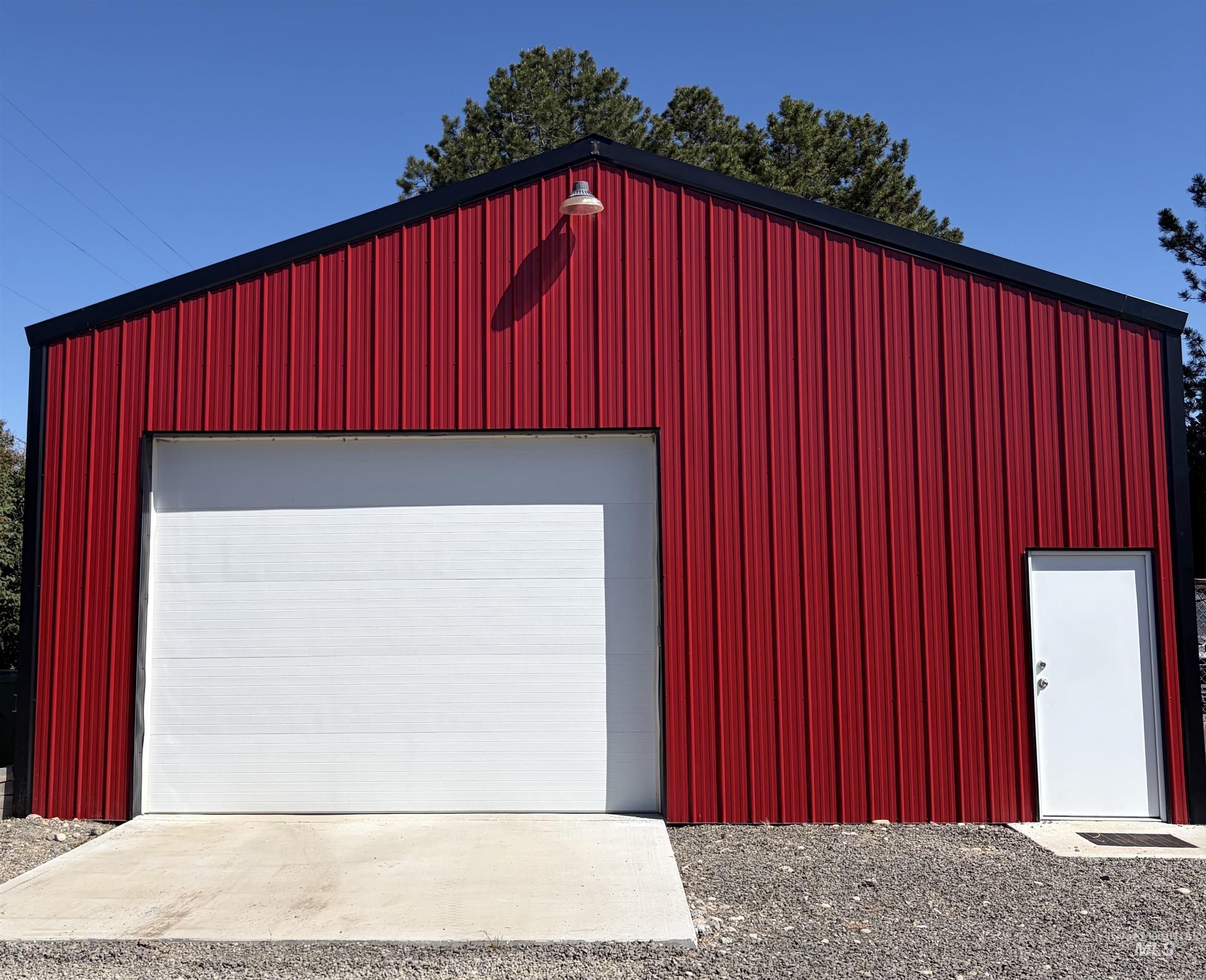 Red metal siding structure featuring a black trim roofline