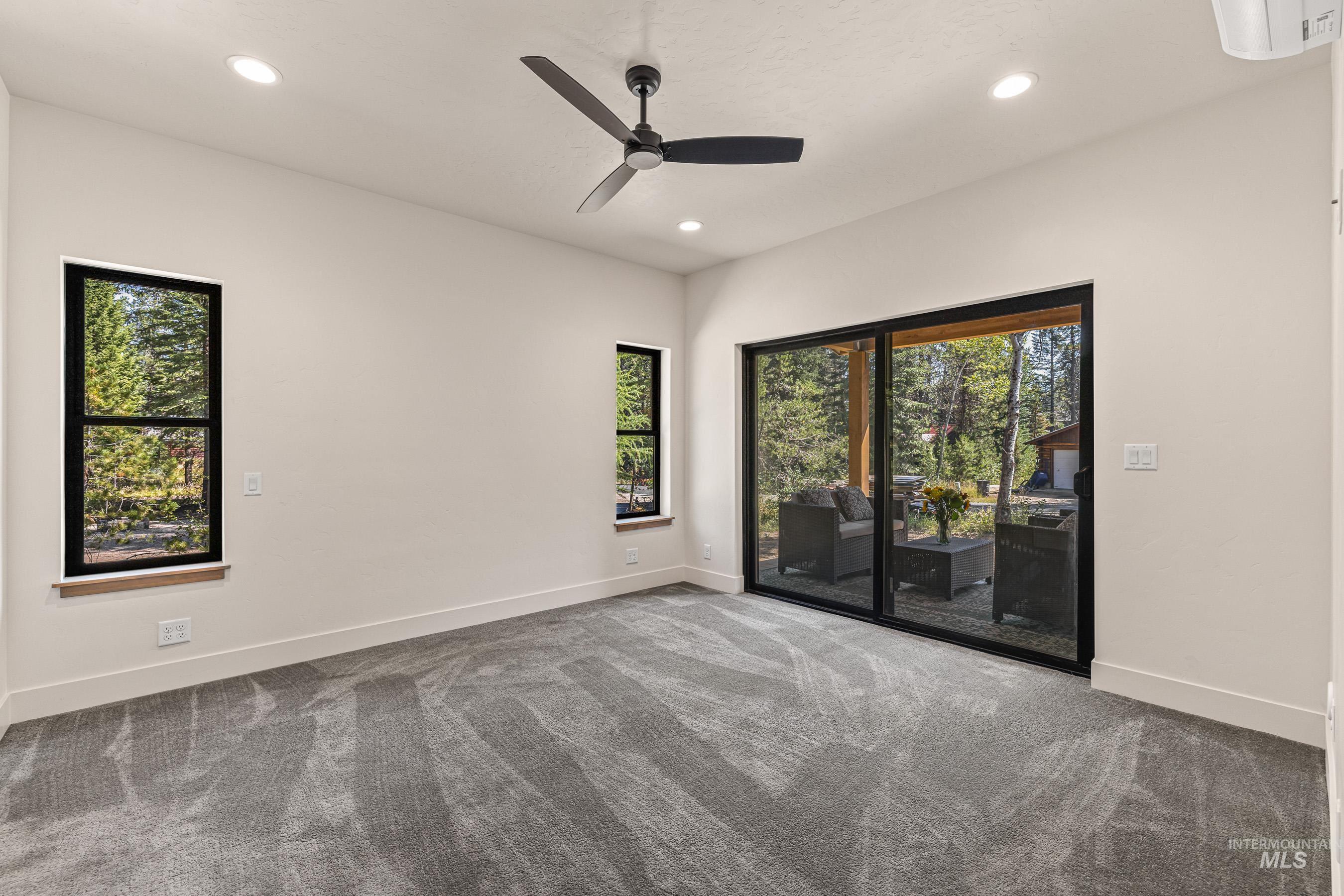 Carpeted empty room with recessed lighting and ceiling fan