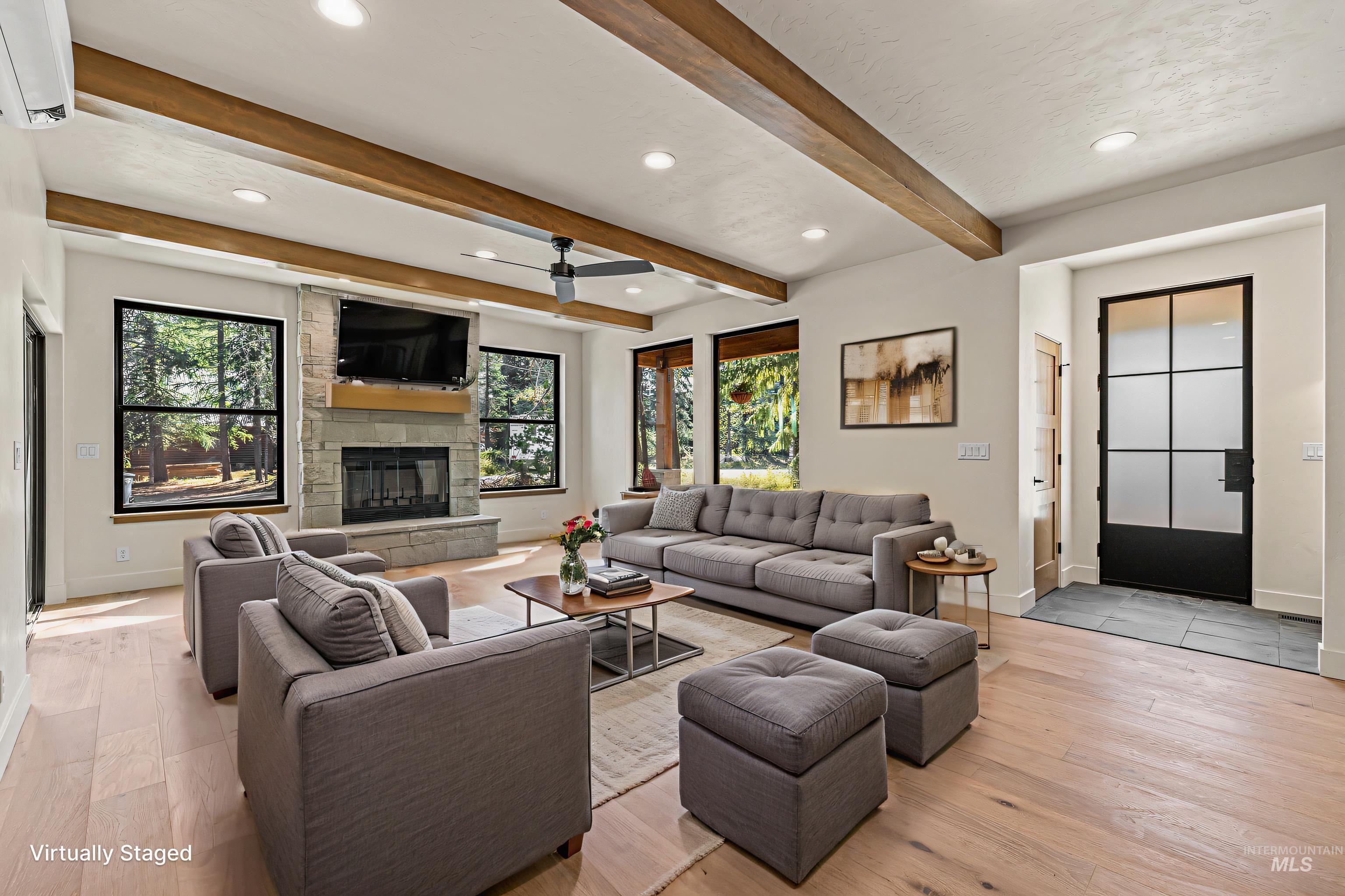 Living area with recessed lighting, light wood-style floors, a stone fireplace, and ceiling fan