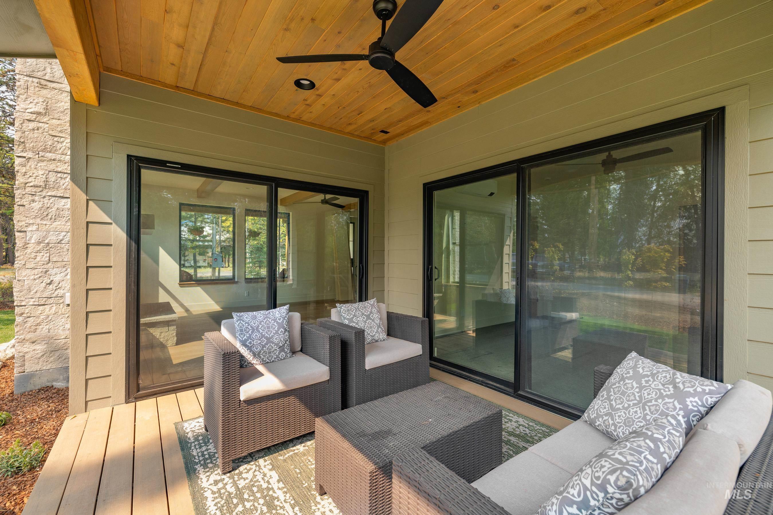 Wooden deck with ceiling fan and outdoor seating