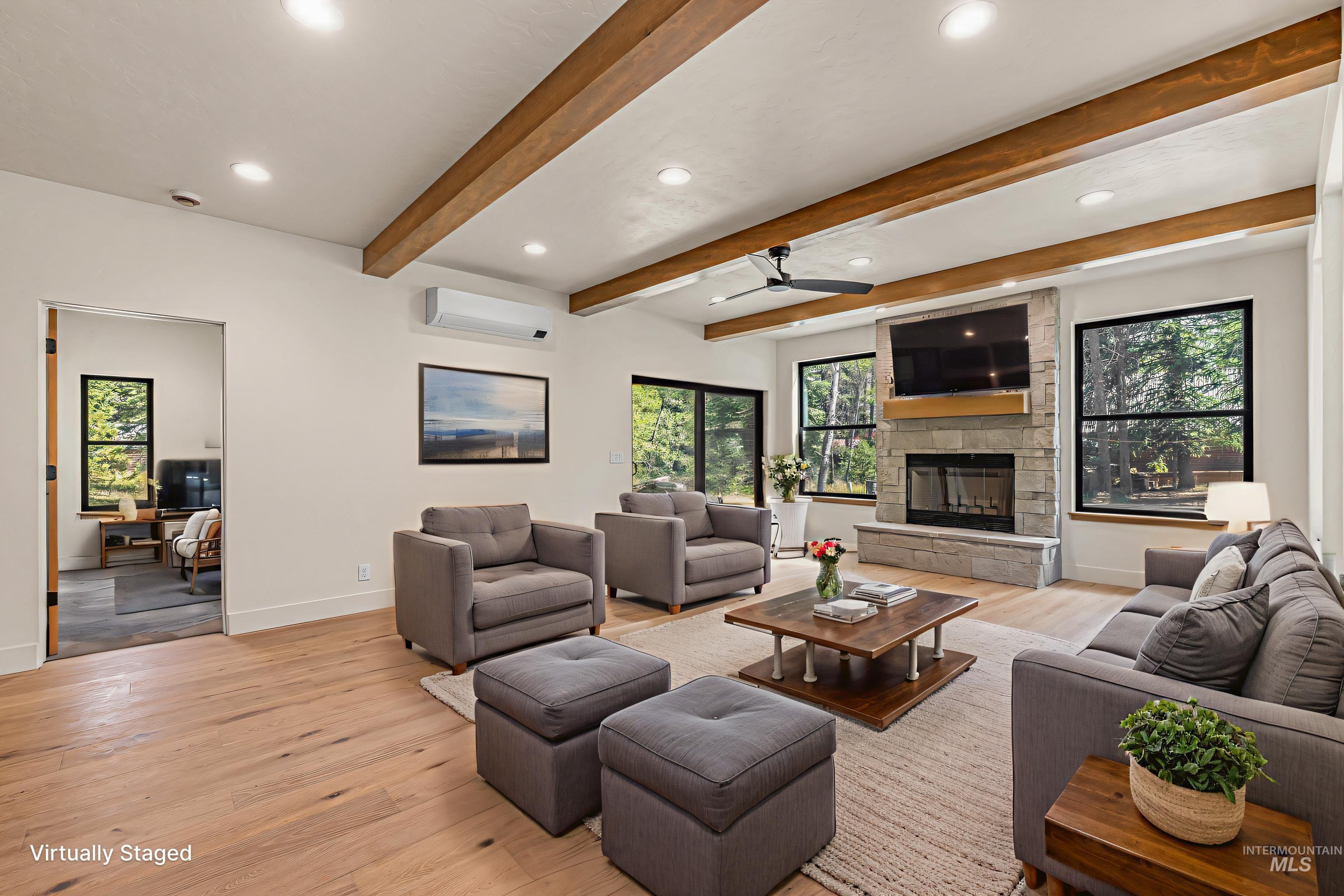 Living area with light wood-style floors, recessed lighting, a ceiling fan, plenty of natural light, and beam ceiling