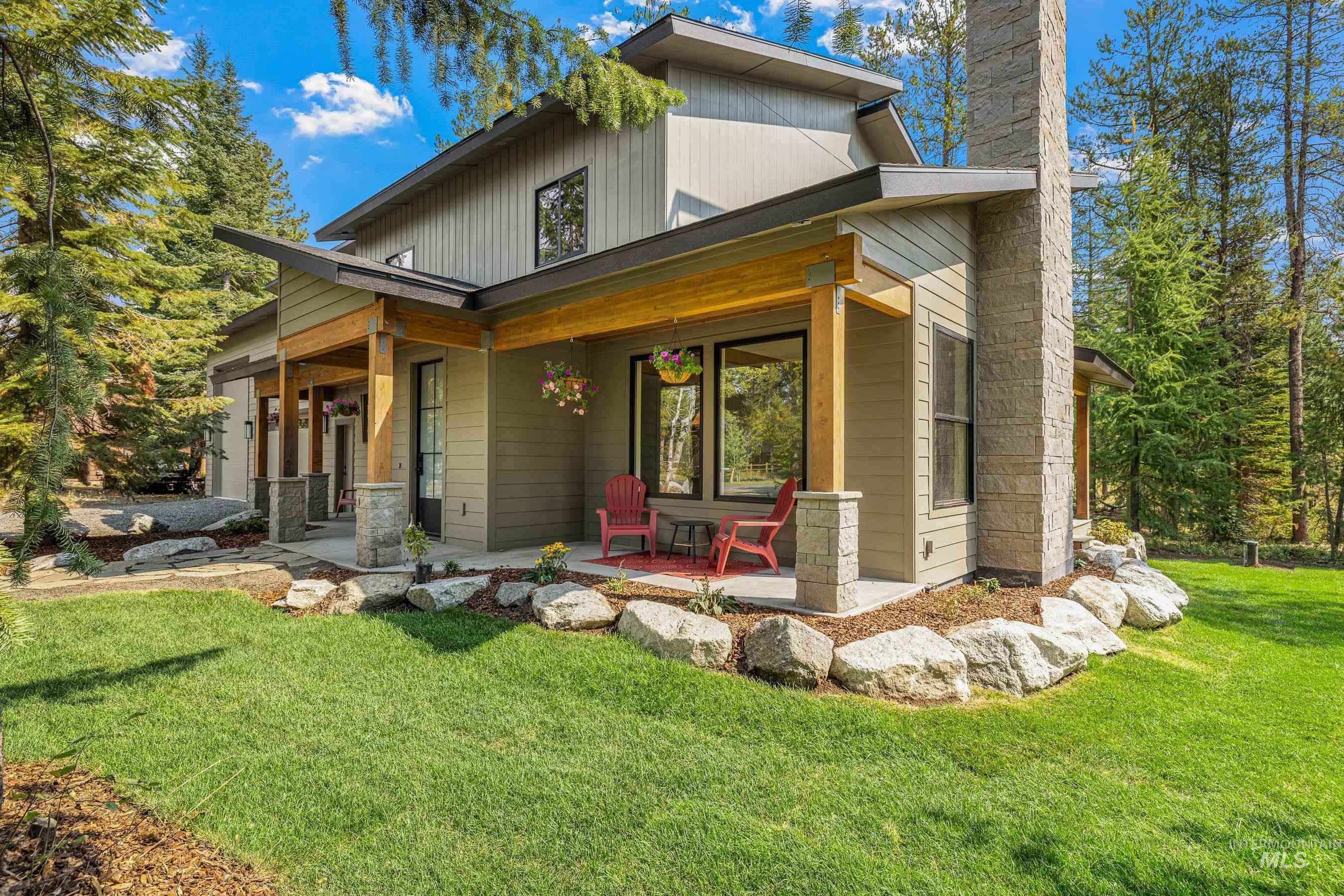 Rear view of house with a yard and a porch