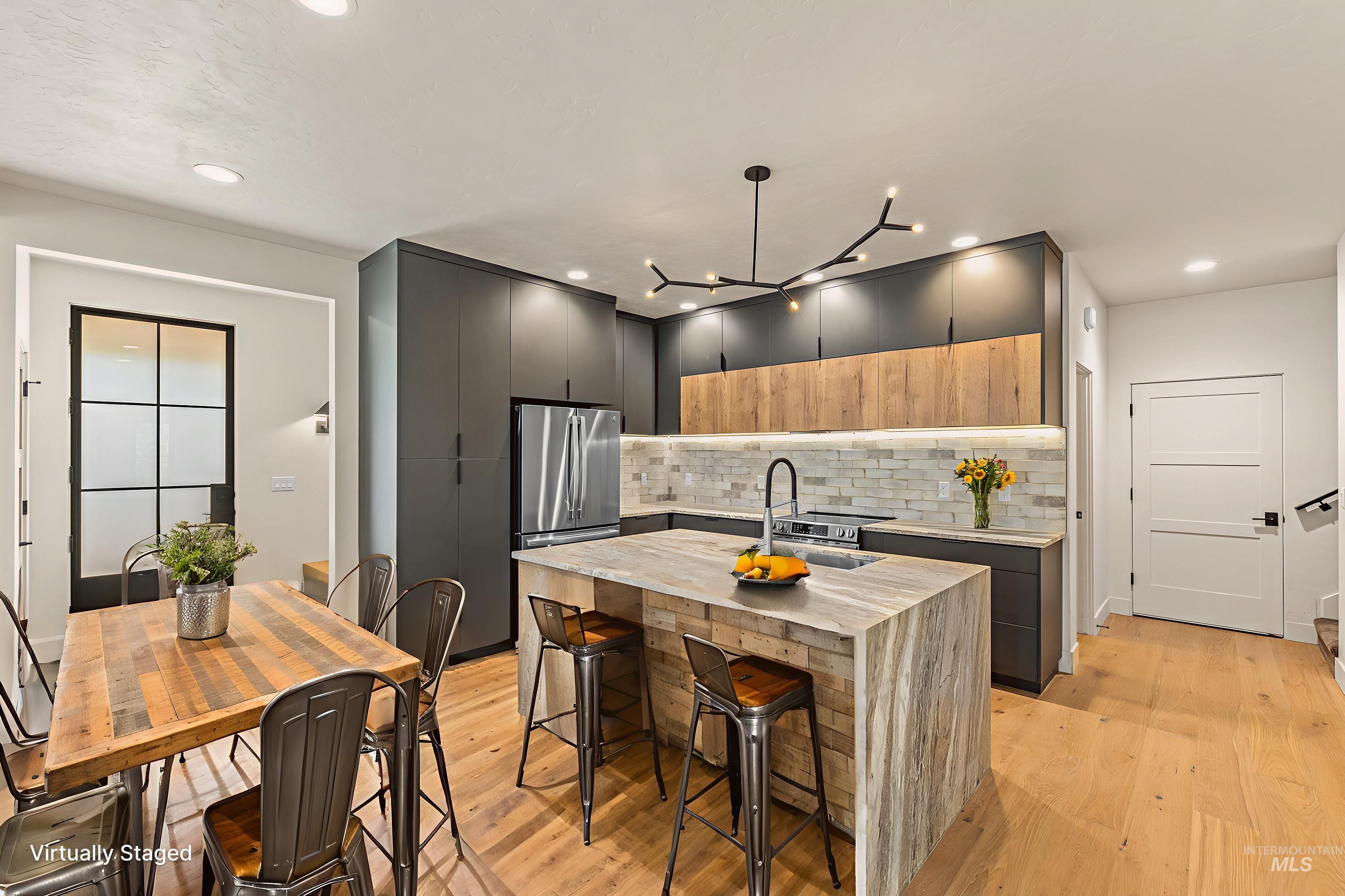 Dual tone kitchen with modern cabinets, light wood-style flooring, two tone color scheme, light stone counters, and recessed lighting