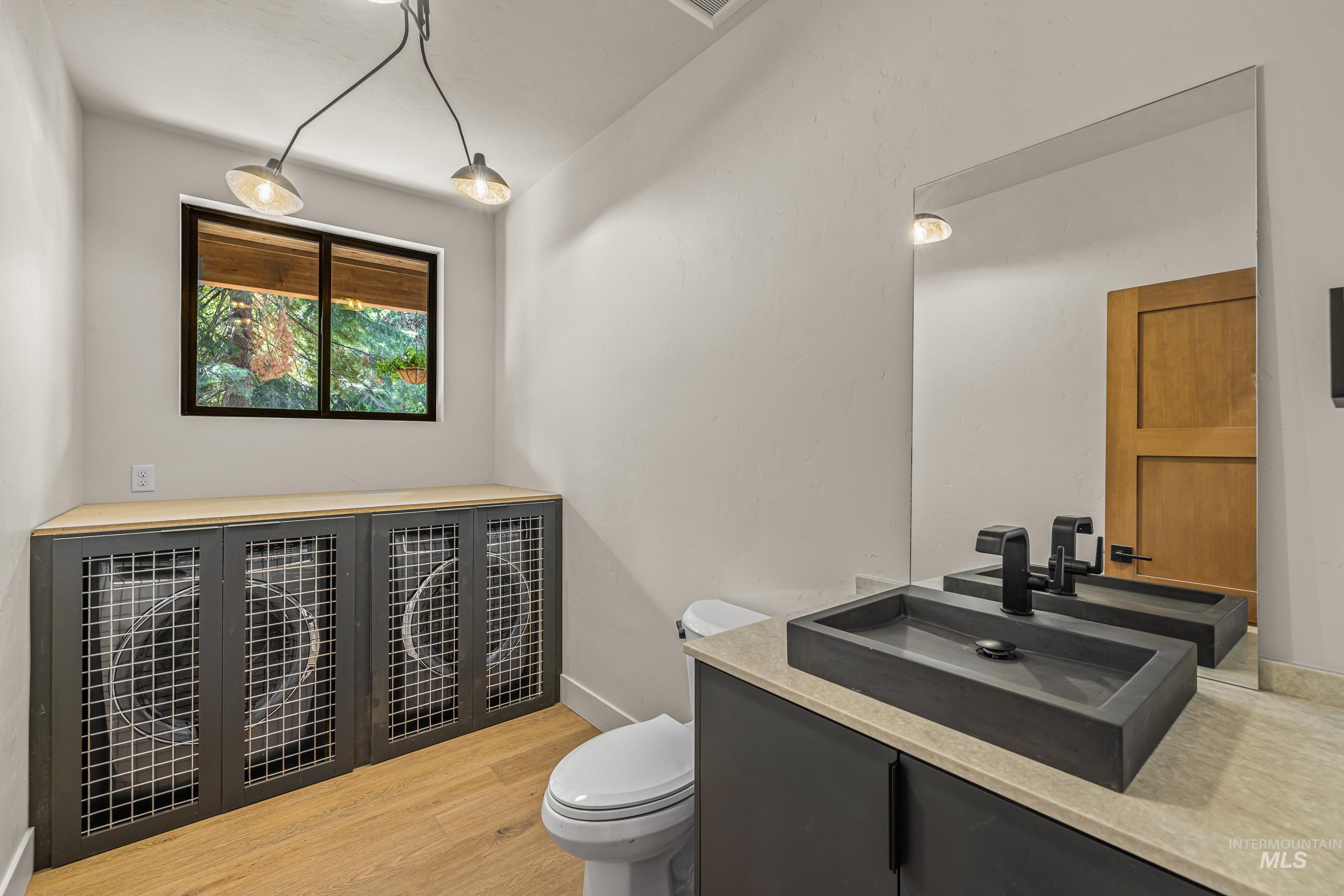 Half bathroom featuring vanity and light wood finished floors
