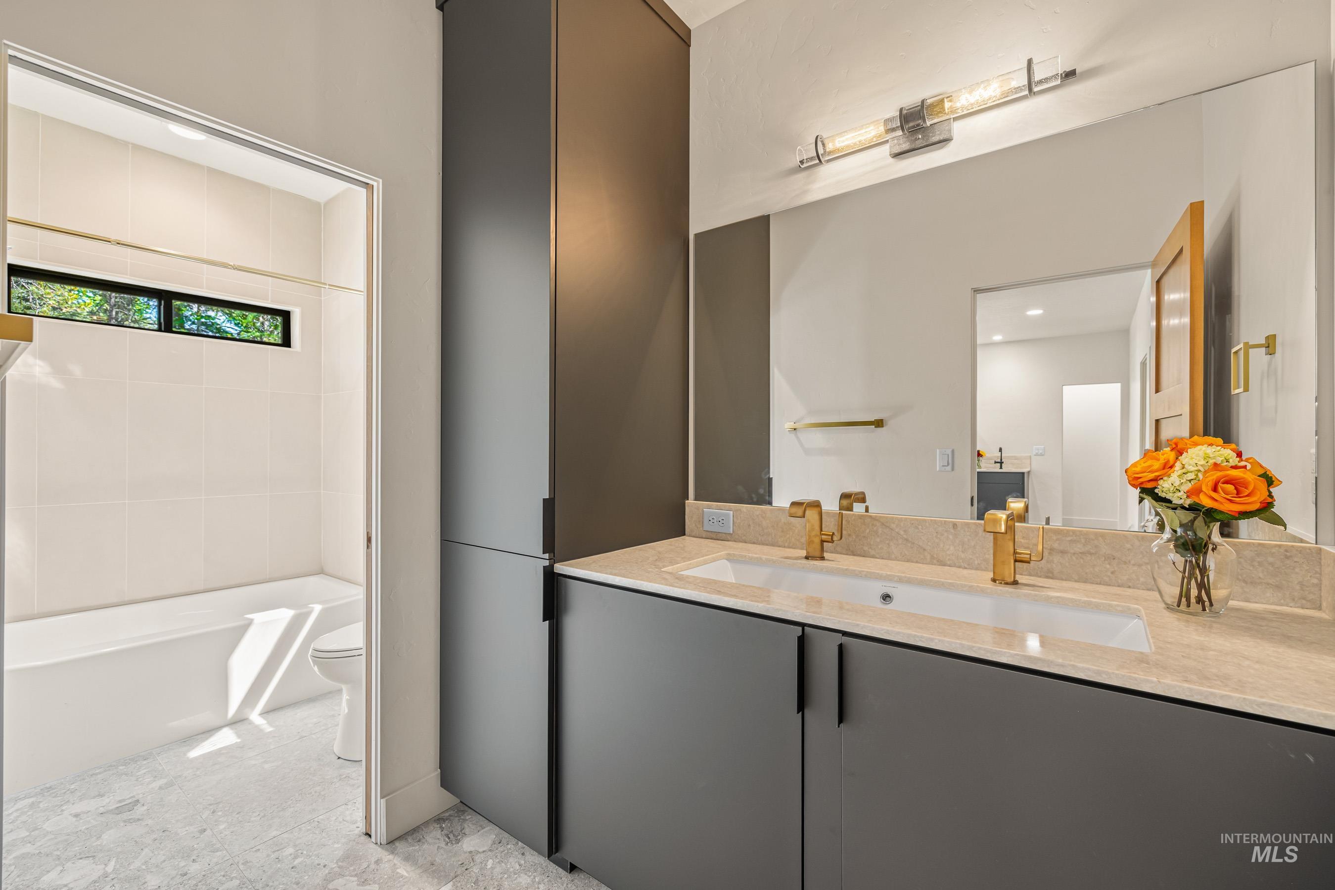 Full bath with vanity and shower / tub combination