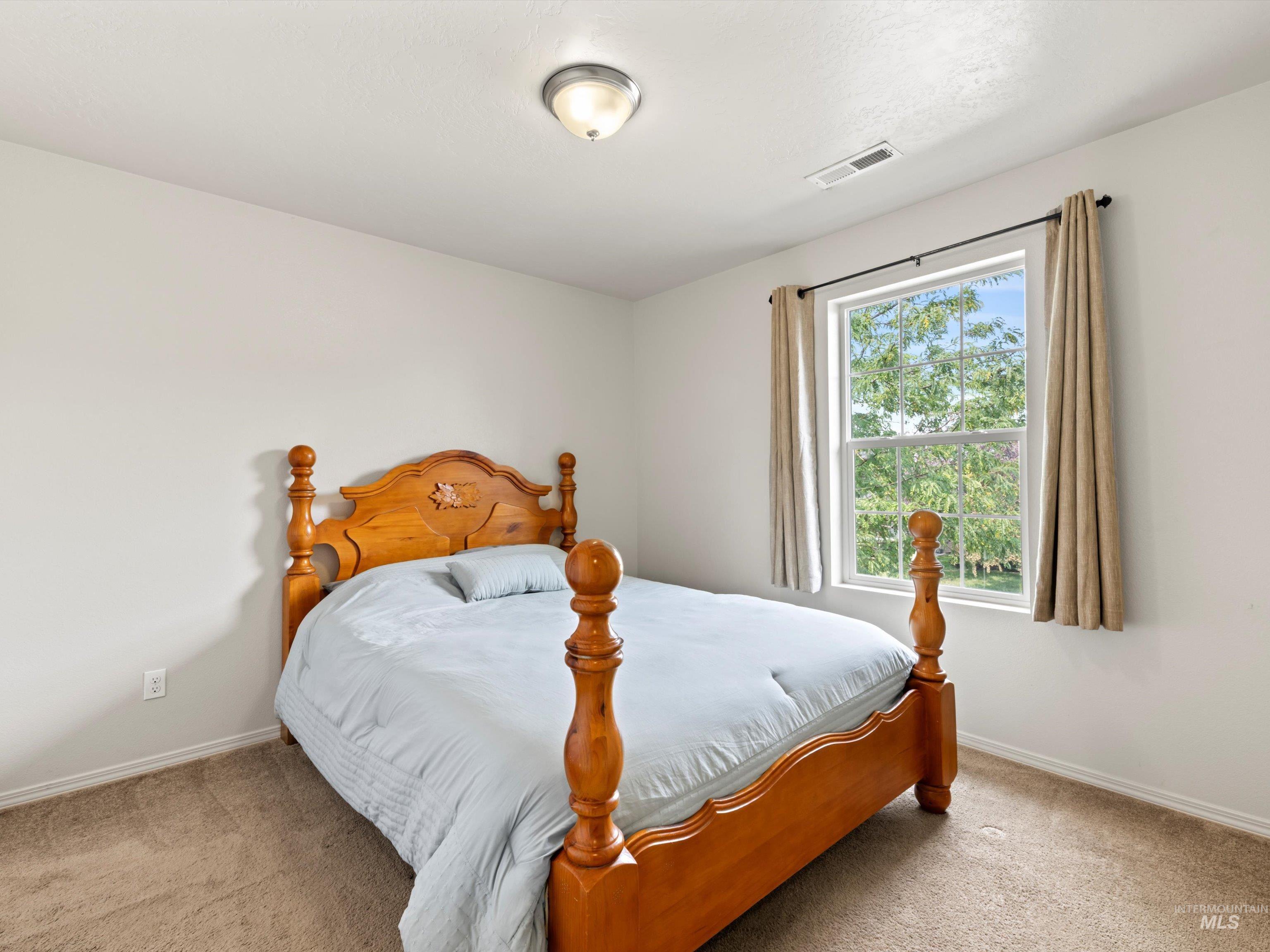 Carpeted bedroom with baseboards