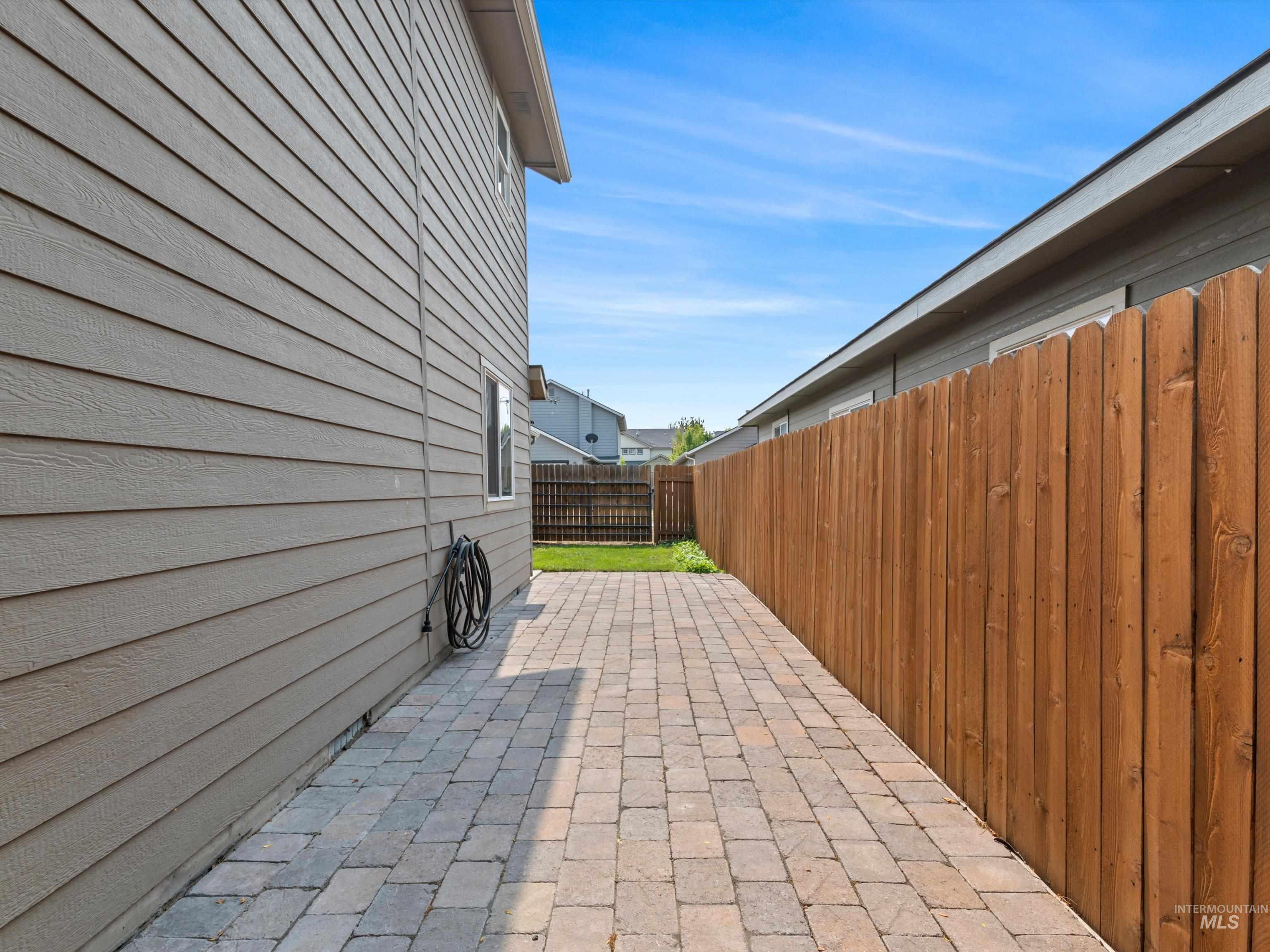 Fenced backyard with a patio
