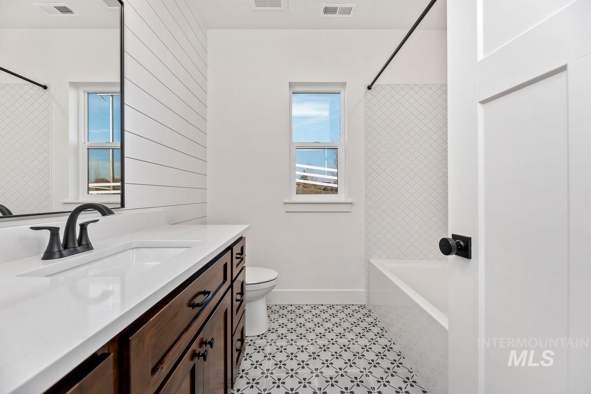 Bathroom with vanity and shower / washtub combination