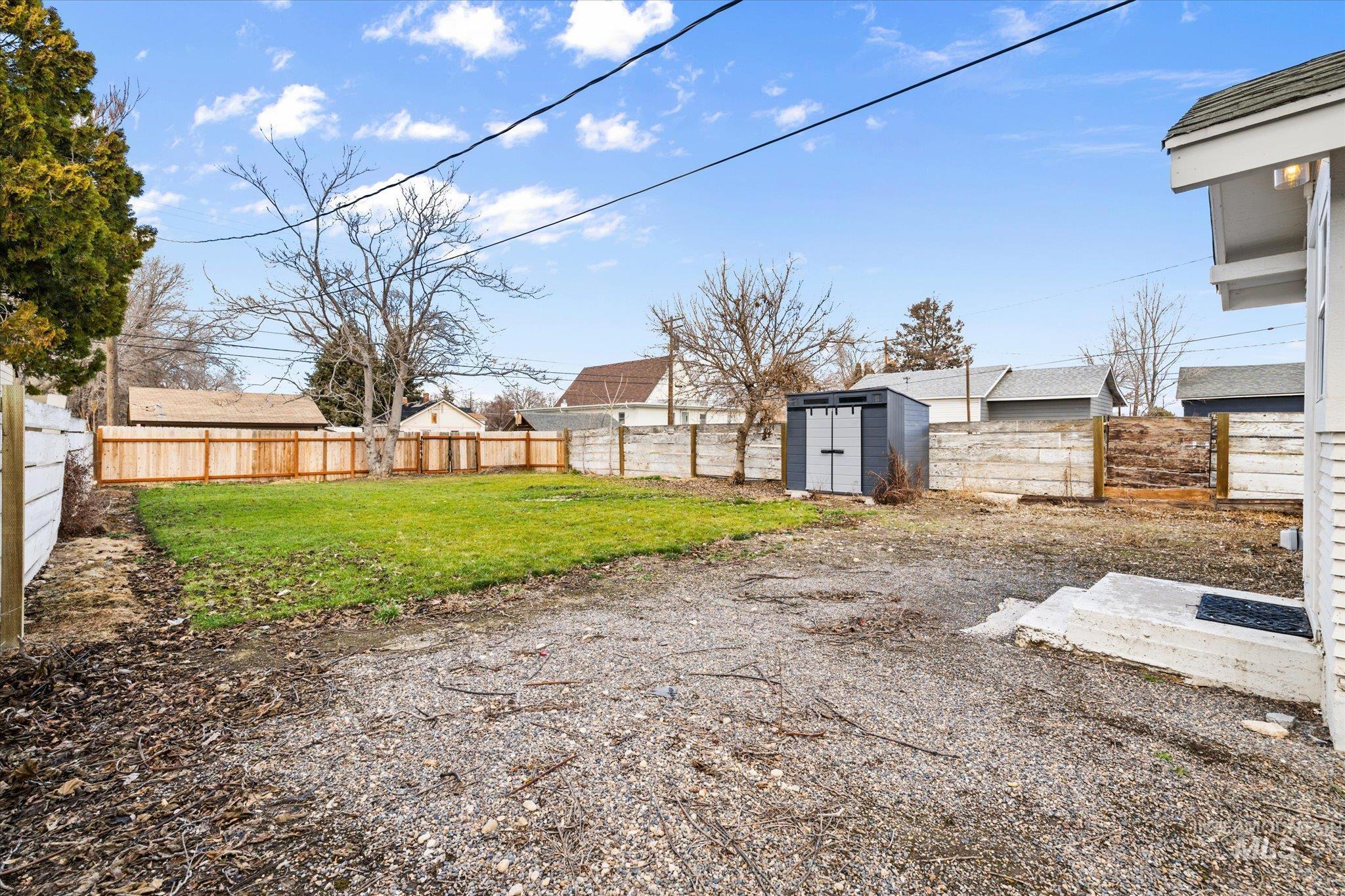 Fenced backyard with a shed