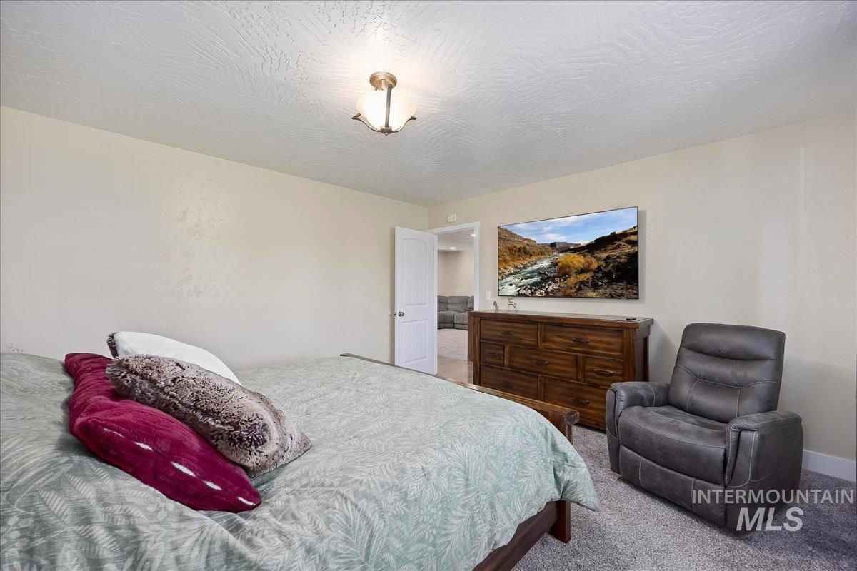 Bedroom with carpet and a textured ceiling