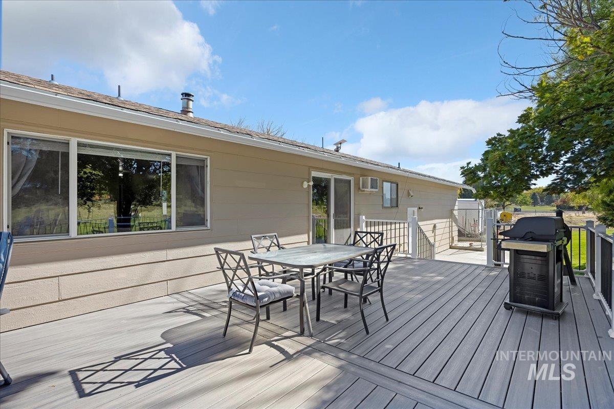 Deck featuring outdoor dining area and area for grilling