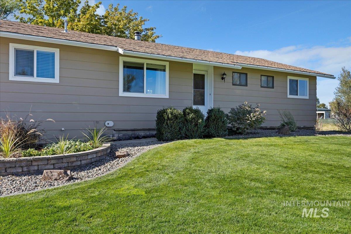 Ranch-style home featuring a front yard
