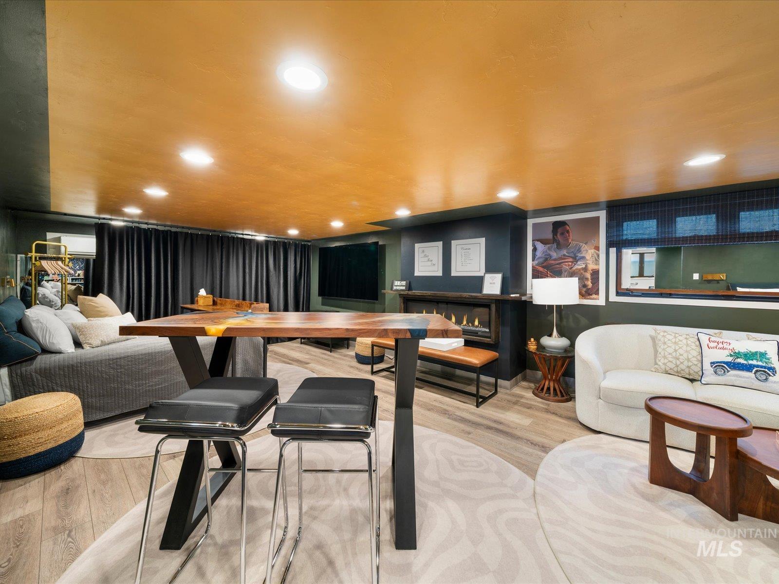 Bar area featuring a lit fireplace and recessed lighting