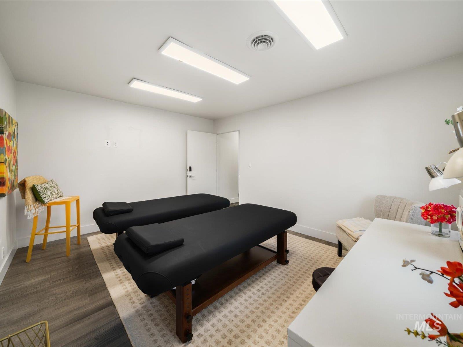 Miscellaneous room featuring wood finished floors and baseboards