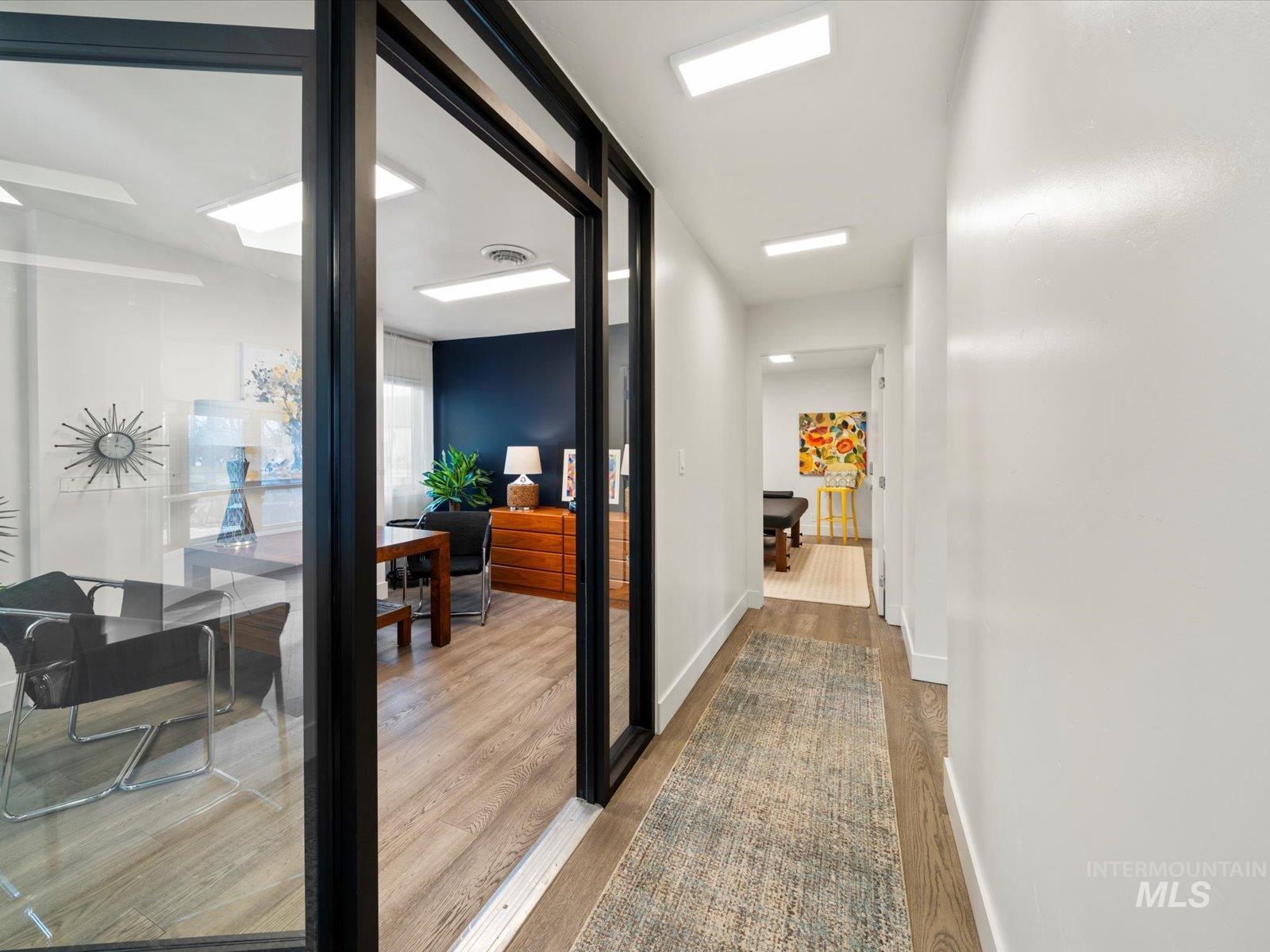 Hallway featuring light wood finished floors