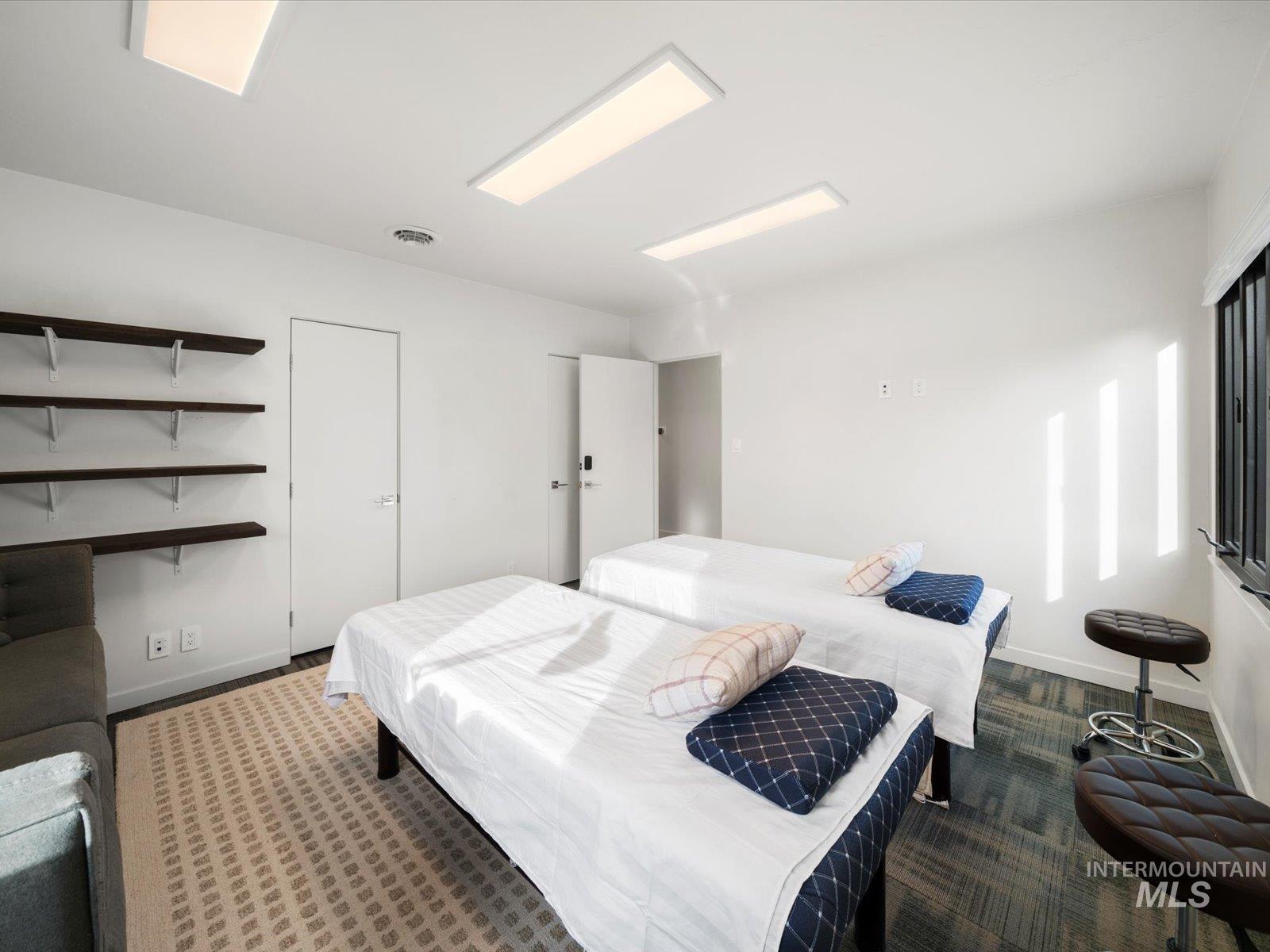 Carpeted bedroom featuring baseboards
